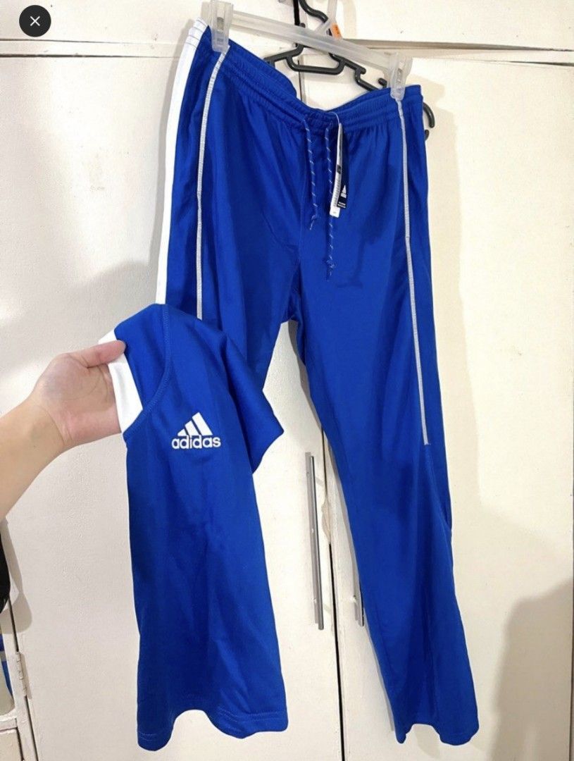 Adidas Tracksuit Pants (Category: Sets & Coordinates) located in Bacoor. Submitted by nd.clothing (Listing ID 1420978914, Image 1). Description: - Adidas tracksuit set - Color: Blue - Includes: Short-sleeved shirt and track pants - Pants size: L - Features: White stripes on pants, Adidas logo on shirt - Pants have drawstring waist.