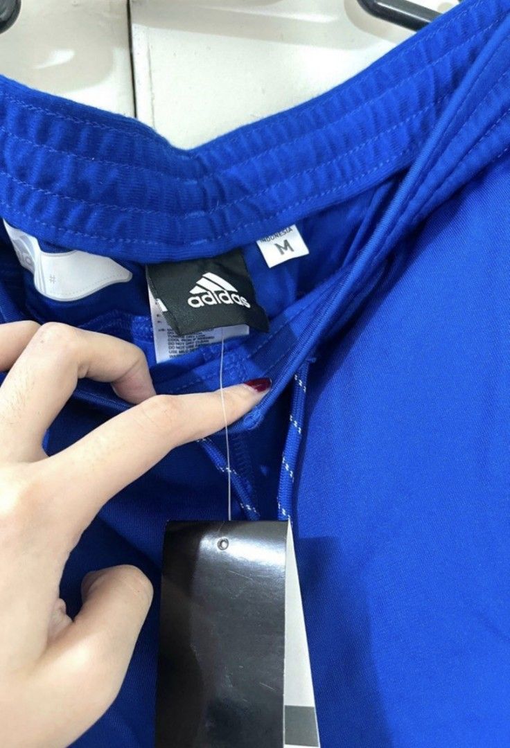 Adidas Tracksuit Pants (Category: Sets & Coordinates) located in Bacoor. Submitted by nd.clothing (Listing ID 1420978914, Image 3). Description: - Adidas tracksuit set - Color: Blue - Includes: Short-sleeved shirt and track pants - Pants size: L - Features: White stripes on pants, Adidas logo on shirt - Pants have drawstring waist.