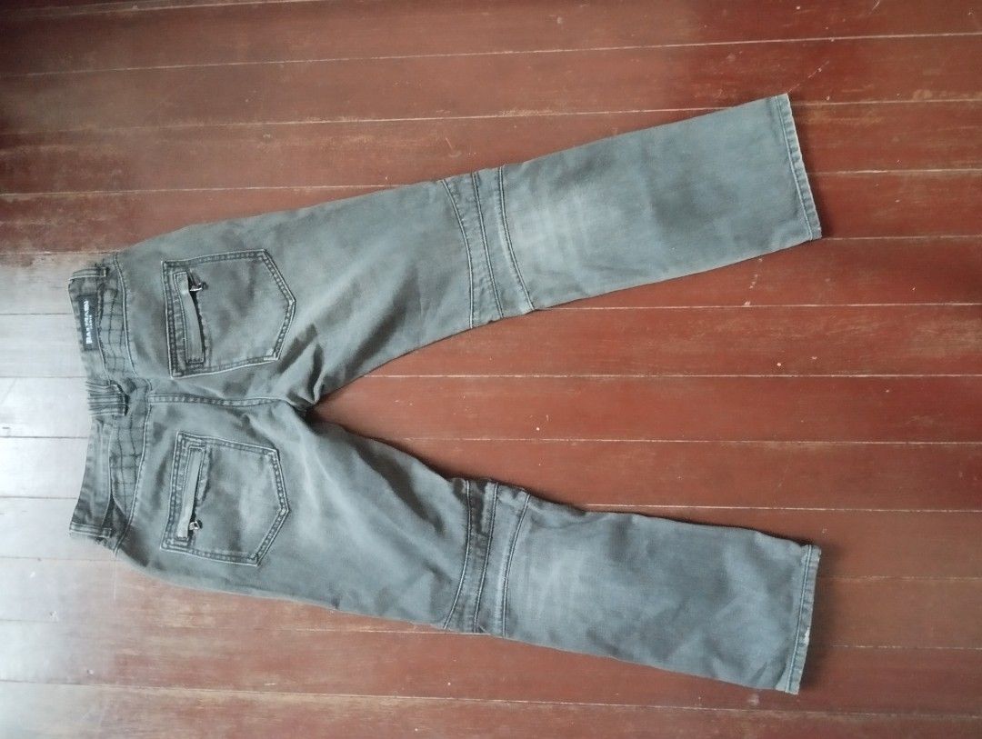Balmain Jeans (Category: Jeans) located in Tanza. Submitted by ezthrift11 (Listing ID 1420942159, Image 2). Description: Grey motorcycle jeans with quilted knee panels and zippered pockets. Straight leg cut. Edgy style. waist 34 Length 39 Leg opening 8.
