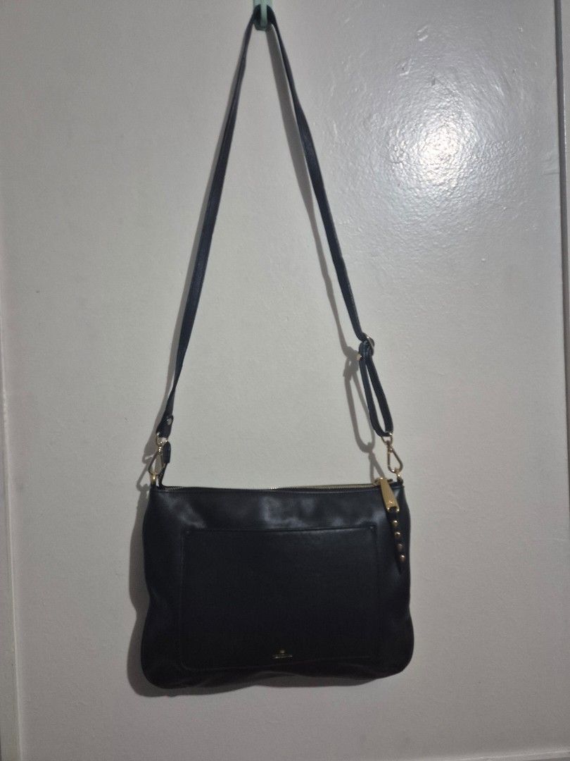 Black Studded Crossbody Bag (Category: Cross-body Bags) located in Quezon City. Submitted by conchicken (Listing ID 1421114800, Image 2). Description: - Black leather crossbody bag - Gold-colored studs and hardware - Adjustable long strap - Front pocket - Zipper closure - Crown logo detail - No flaw.