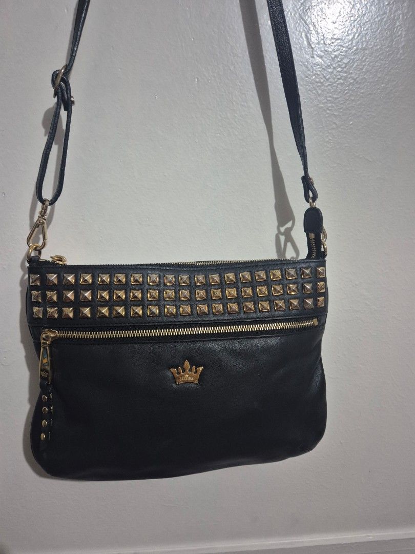 Black Studded Crossbody Bag (Category: Cross-body Bags) located in Quezon City. Submitted by conchicken (Listing ID 1421114800, Image 1). Description: - Black leather crossbody bag - Gold-colored studs and hardware - Adjustable long strap - Front pocket - Zipper closure - Crown logo detail - No flaw.
