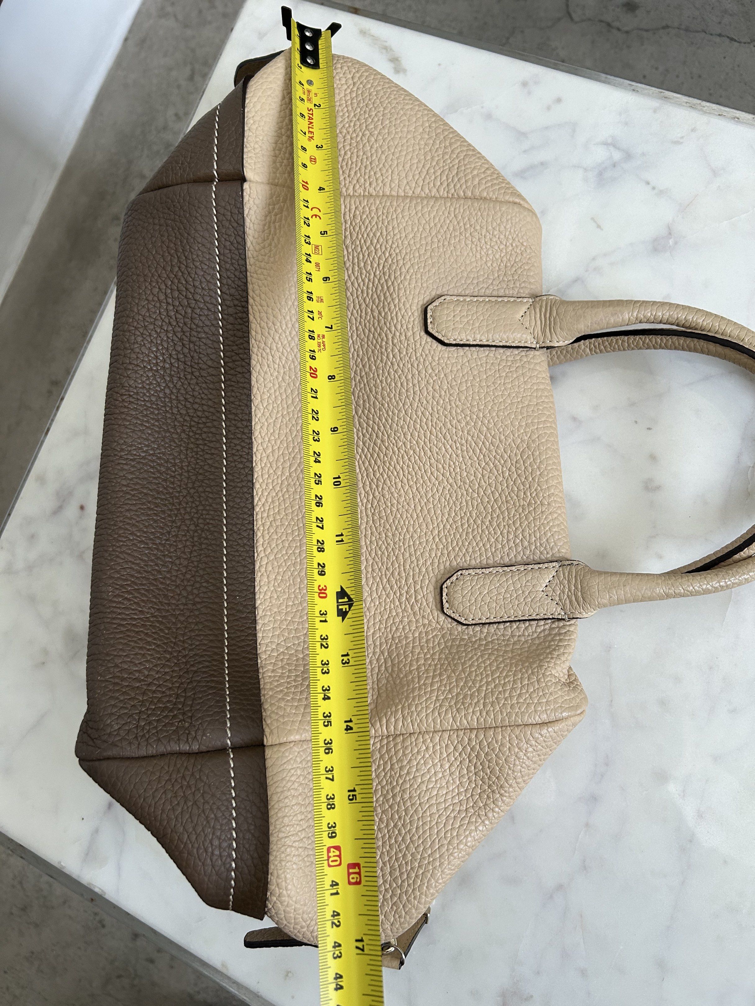 Bruno Magli Leather Hand/Sling Bag (Category: Luxury Bags & Wallets) located in Manila. Submitted by zolnak (Listing ID 1421001394, Image 2). Description: Barely used. Very good condition. Cube shaped when full inside. Two tone authentic leather. Top zipper closure. Dual handles. Detachable shoulder strap. Interior zippered pocket. Nice overnight bag. Buyer to shoulder shipping. .