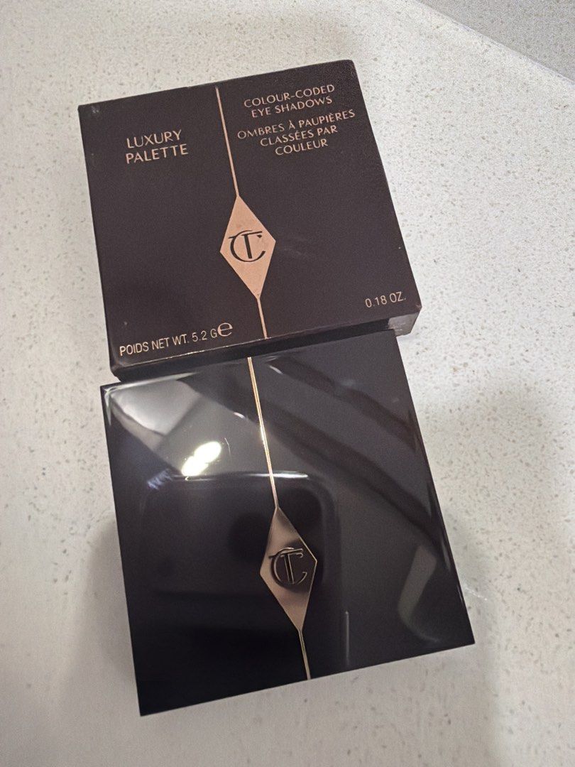 Charlotte Tilbury Luxury Palette (Category: Makeup) located in Cainta. Submitted by mycosy.life (Listing ID 1421065545, Image 1). Description: - Charlotte Tilbury Luxury Palette - Features four eyeshadow shades - Compact design with black and gold trim - Net weight: 5.2g / 0.18 oz - Includes a mix of neutral and burgundy shades.