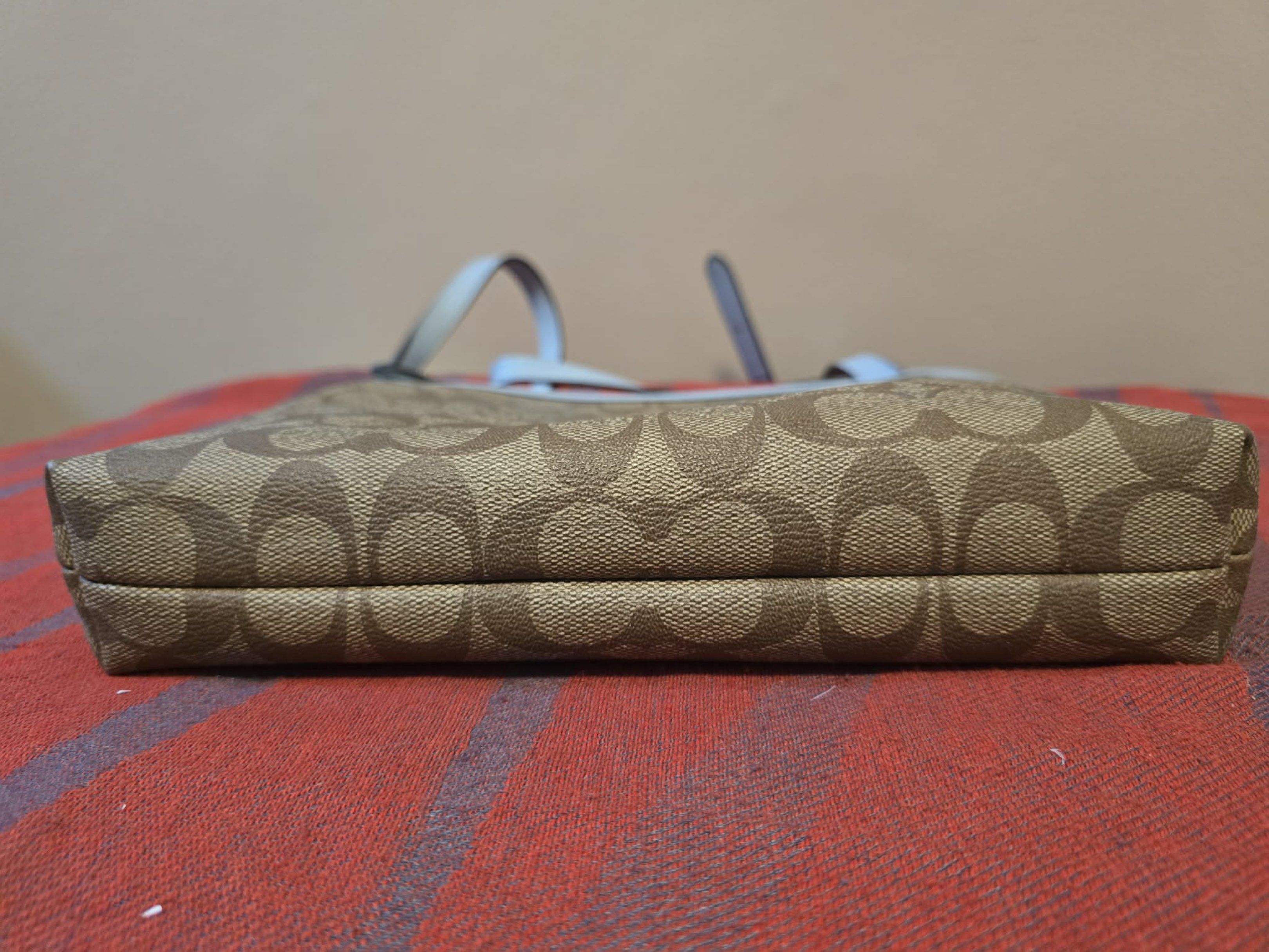 Coach Signature Crossbody Bag (Category: Luxury Bags & Wallets) located in Antipolo. Submitted by cmss1998 (Listing ID 1421031670, Image 3). Description: Selling this beautiful Coach Signature crossbody bag featuring the classic brown “C” monogram canvas with light blue leather trim and strap. Perfect for everyday use – lightweight, stylish, and easy to match with any outfit. Details: • Brand: Coach New York • Style No.: D1847-F29210 • Color: Bro