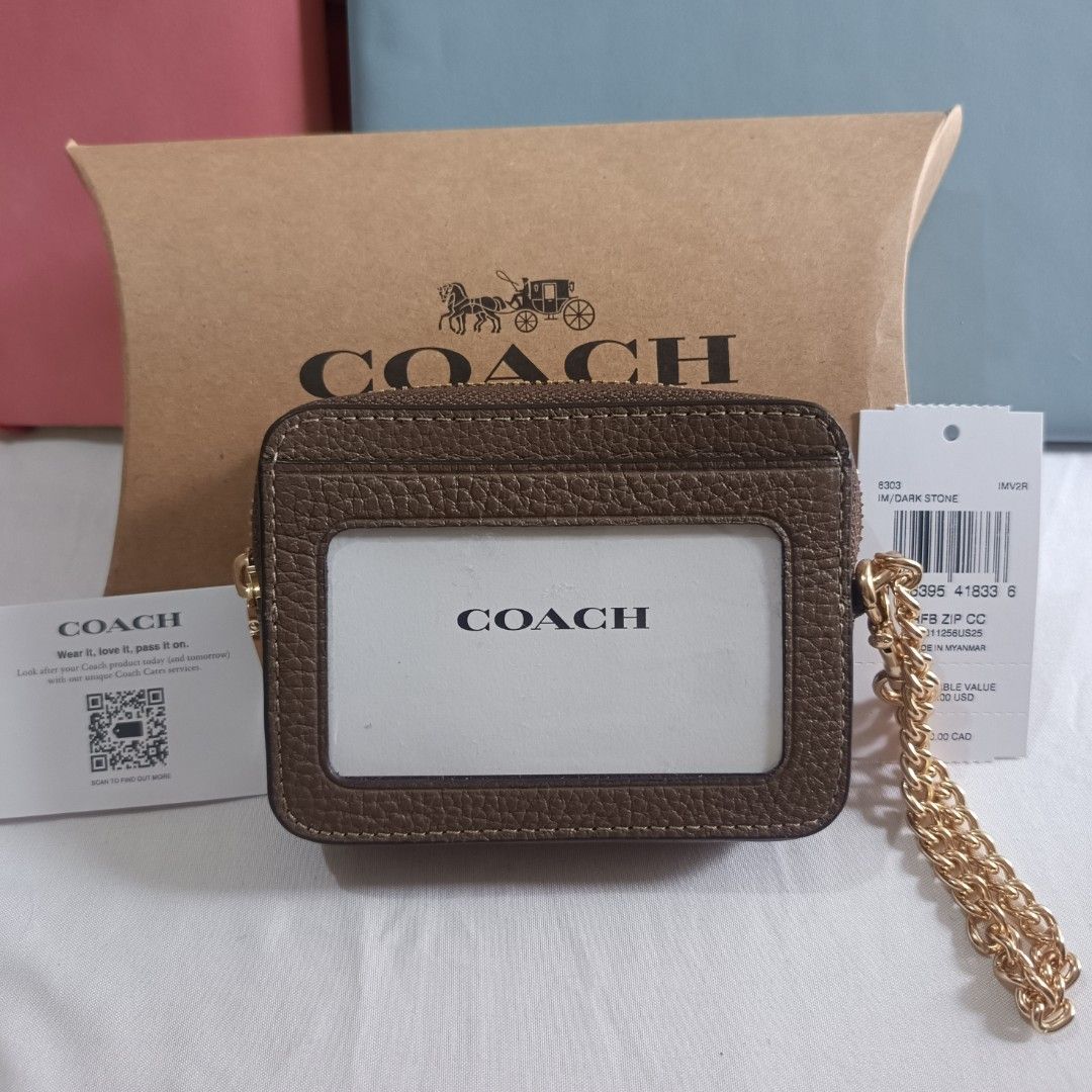 Coach Zip Card Case with Chain (Category: Luxury Bags & Wallets) located in Dagupan City. Submitted by nmcmp4 (Listing ID 1420995935, Image 2). Description: - Coach zip card case with chain - Brown leather exterior - Gold-tone zipper and chain - Features card slots - Clear ID window - Includes original packaging and tags - Coach logo embossed on front - 4 in x 3 in .