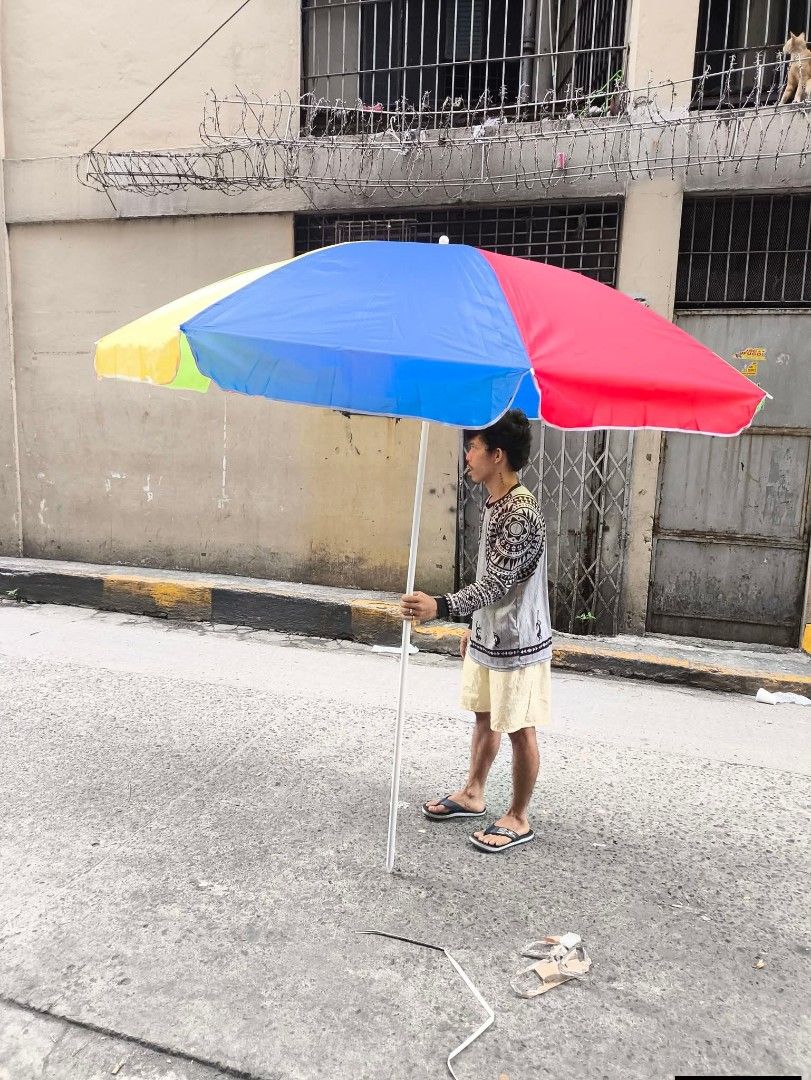 Colorful Beach Umbrella 45" (Category: Umbrellas) located in Manila. Submitted by yzlshop (Listing ID 1420963926, Image 1). Description: - Vibrant umbrella for beach or outdoor use. - Features a colorful design with red, blue, yellow, and green panels. - White pole. - Simple design..