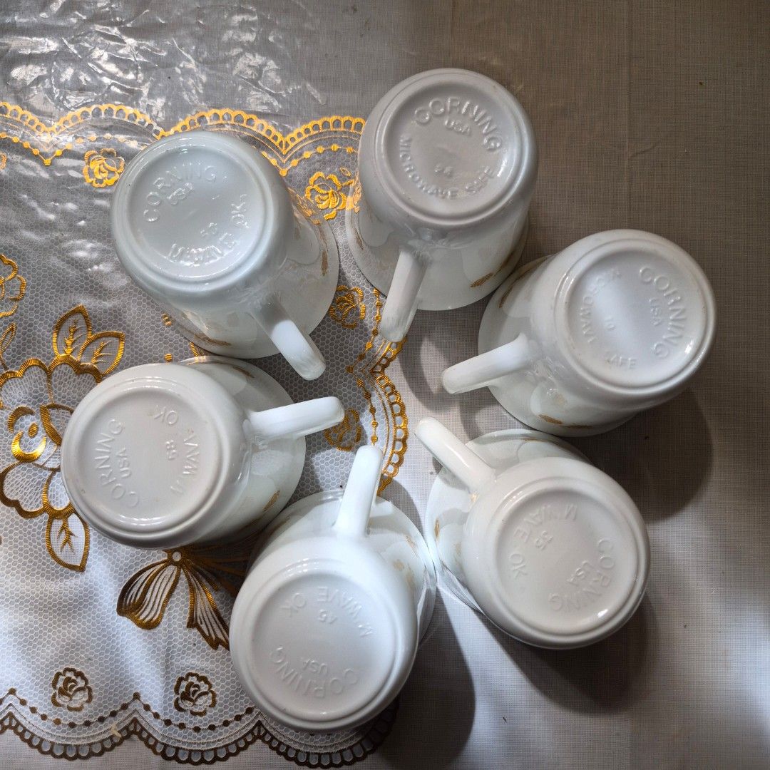 Corning Ware Floral Mug Set (Category: Coffee & Tea Tableware) located in Manila. Submitted by mkalelx (Listing ID 1406506429, Image 3). Description: - Set of 6 Corning Ware mugs - Classic white base with gold floral pattern - Each mug has a handle - Marked "Corning USA" - Microwave safe.
