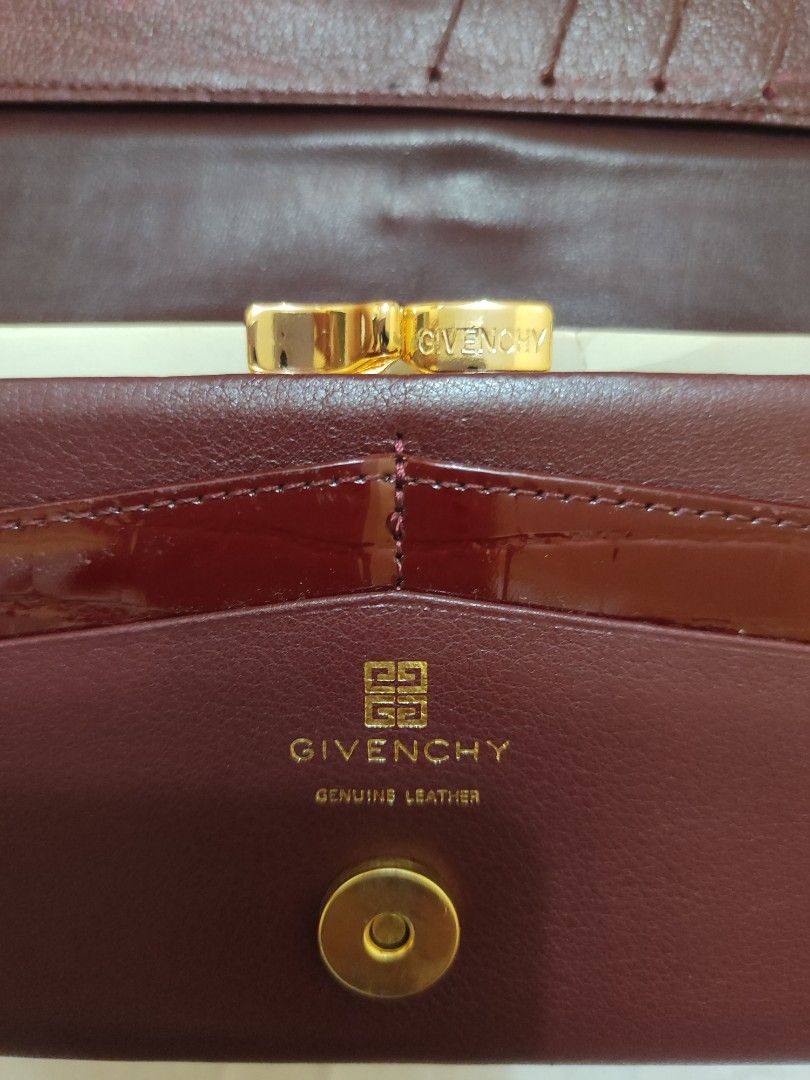 Givenchy Genuine Leather Wallet (Category: Luxury Bags & Wallets) located in Paniqui. Submitted by arlenepari29210 (Listing ID 1421008590, Image 2). Description: - Givenchy burgundy leather wallet - Gold-toned hardware - Multiple card slots - Coin compartment - Snap and clasp closures - Givenchy logo detail - Genuine leather construction - Burgundy interior.