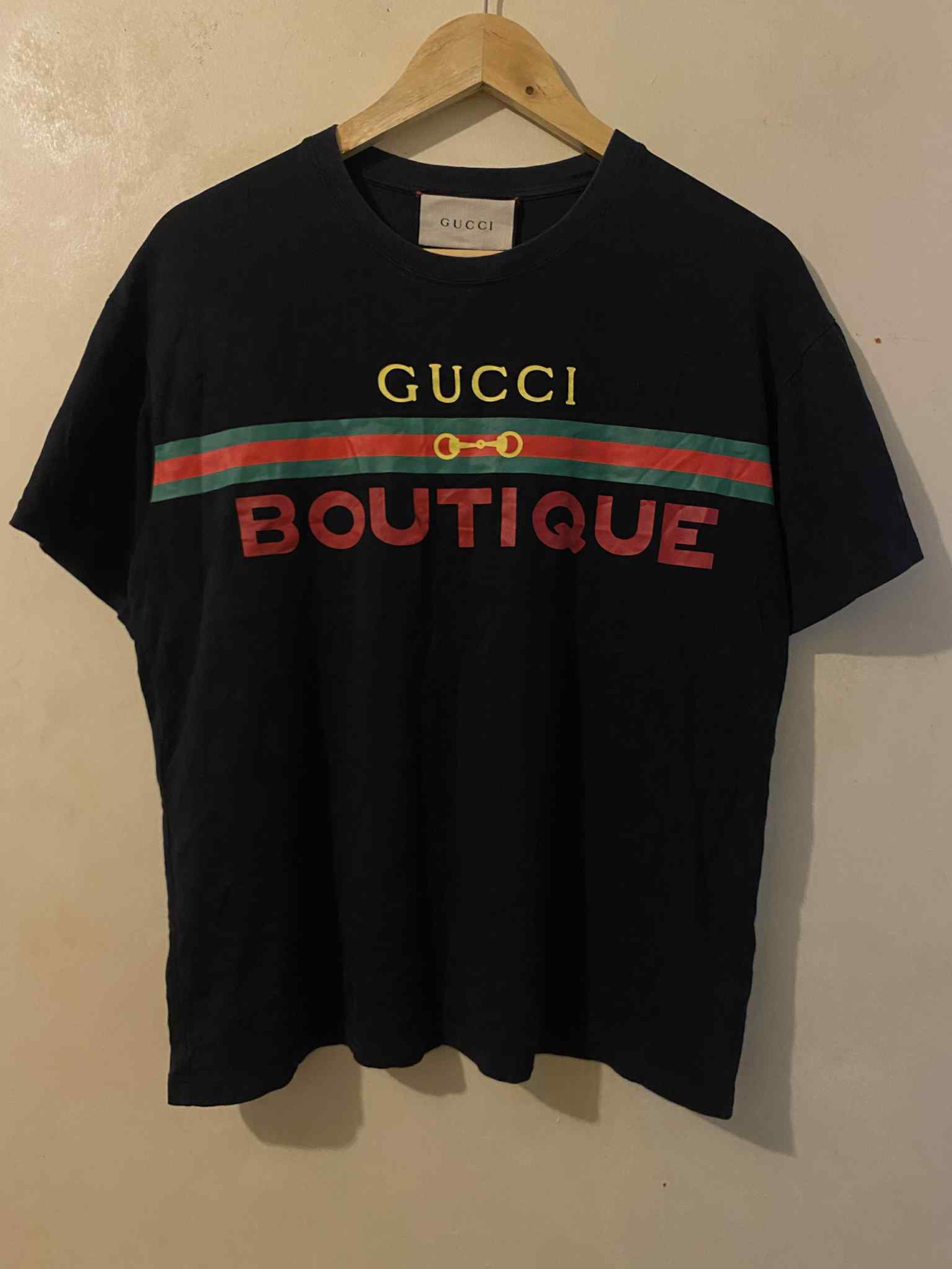 Gucci Boutique Black Shirt (Category: Luxury Apparel) located in Cagayan de Oro. Submitted by timeless.ph (Listing ID 1421041205, Image 2). Description: Size: M Width: 21 Length: 25 Color rate: 9.8/10 Condition: Excellent Issue: Plus shipping fee *color may vary due to lighting*.