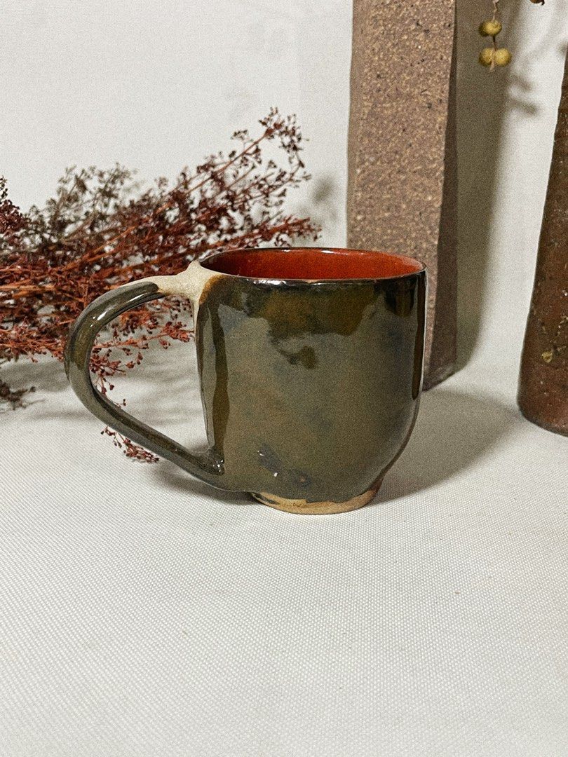 Handmade Ceramic Mug (Category: Coffee & Tea Tableware) located in Antipolo. Submitted by ceramiqueph (Listing ID 1421023571, Image 2). Description: - Handmade ceramic mug - Unique design - Red interior - Burnt orange and brown glaze - Sturdy and well-crafted - Perfect for beverages - Rustic, artisanal feel.