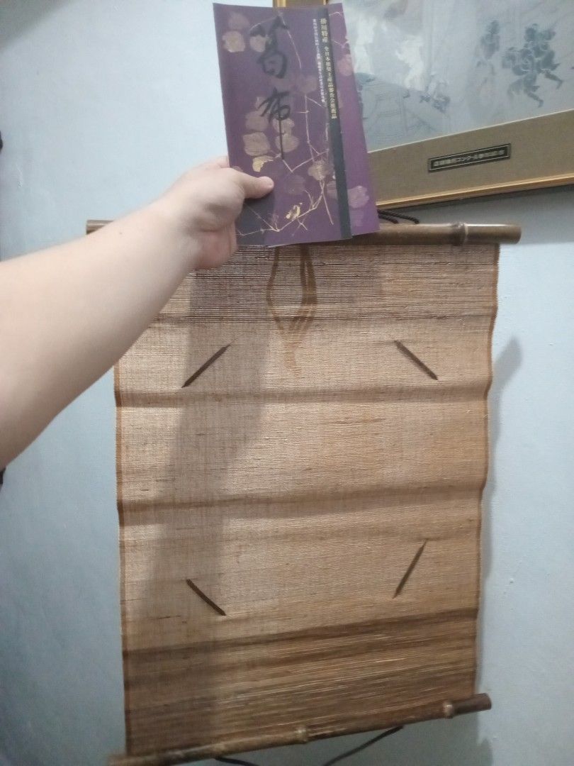 Japanese Wall Scroll (Category: Wall Decor) located in Taguig. Submitted by nippon.toki (Listing ID 1421113081, Image 3). Description: - Authentic Japanese wall scroll - Comes in original packaging (box and pamphlet) - Made of woven material - Features wooden rods - Packaging with Japanese characters and logo - Scroll is rolled up and ready to display.