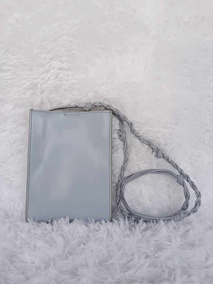 Jil Sander Mini Leather Crossbody Bag (Category: Luxury Bags & Wallets) located in Tarlac. Submitted by khrizson16 (Listing ID 1420940478, Image 1). Description: - Jil Sander crossbody bag - Light blue color - Sleek, rectangular design - Braided strap - Magnetic closure - Interior stamped with Jil Sander logo and "Made in Italy" - Made of leather.