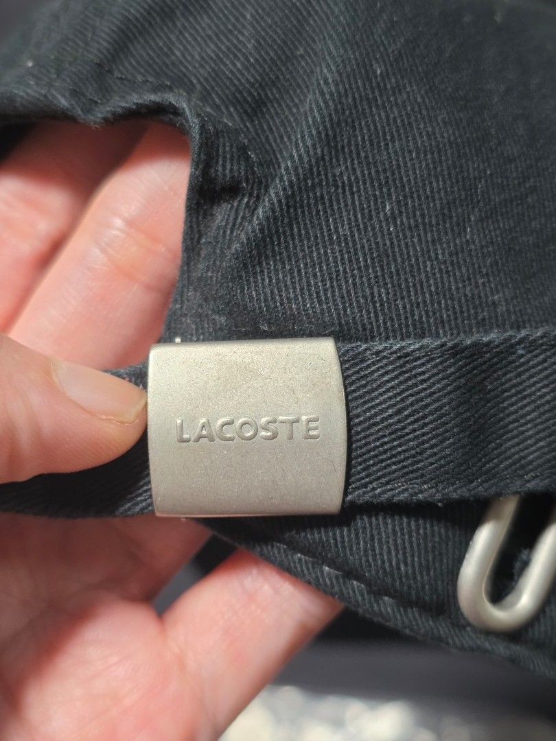 Lacoste Black Cap (Category: Caps & Hats) located in Quezon City. Submitted by yGGGG (Listing ID 1421014143, Image 2). Description: - Lacoste black cap - Features the iconic crocodile logo - Adjustable strap with metal buckle - Made of durable fabric - Comes with original packaging.