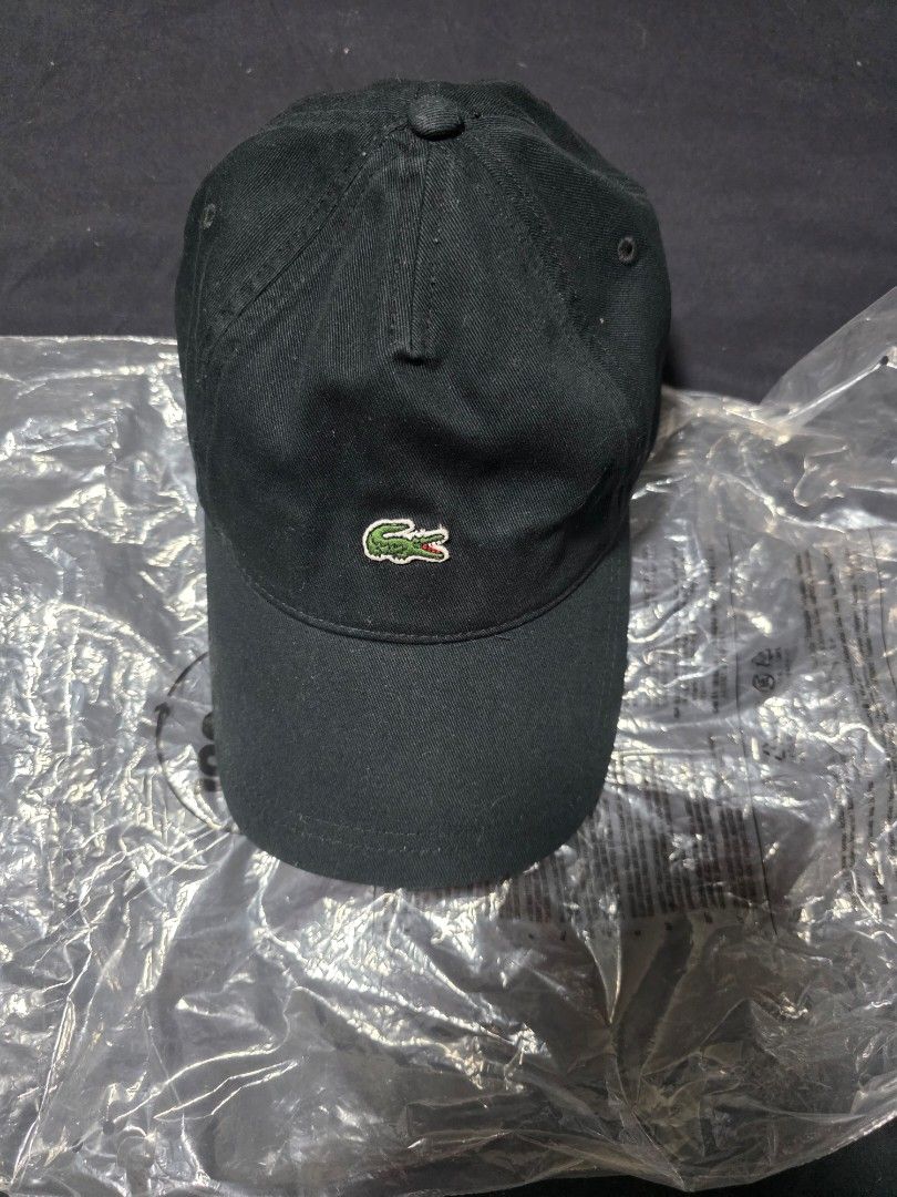 Lacoste Black Cap (Category: Caps & Hats) located in Quezon City. Submitted by yGGGG (Listing ID 1421014143, Image 1). Description: - Lacoste black cap - Features the iconic crocodile logo - Adjustable strap with metal buckle - Made of durable fabric - Comes with original packaging.