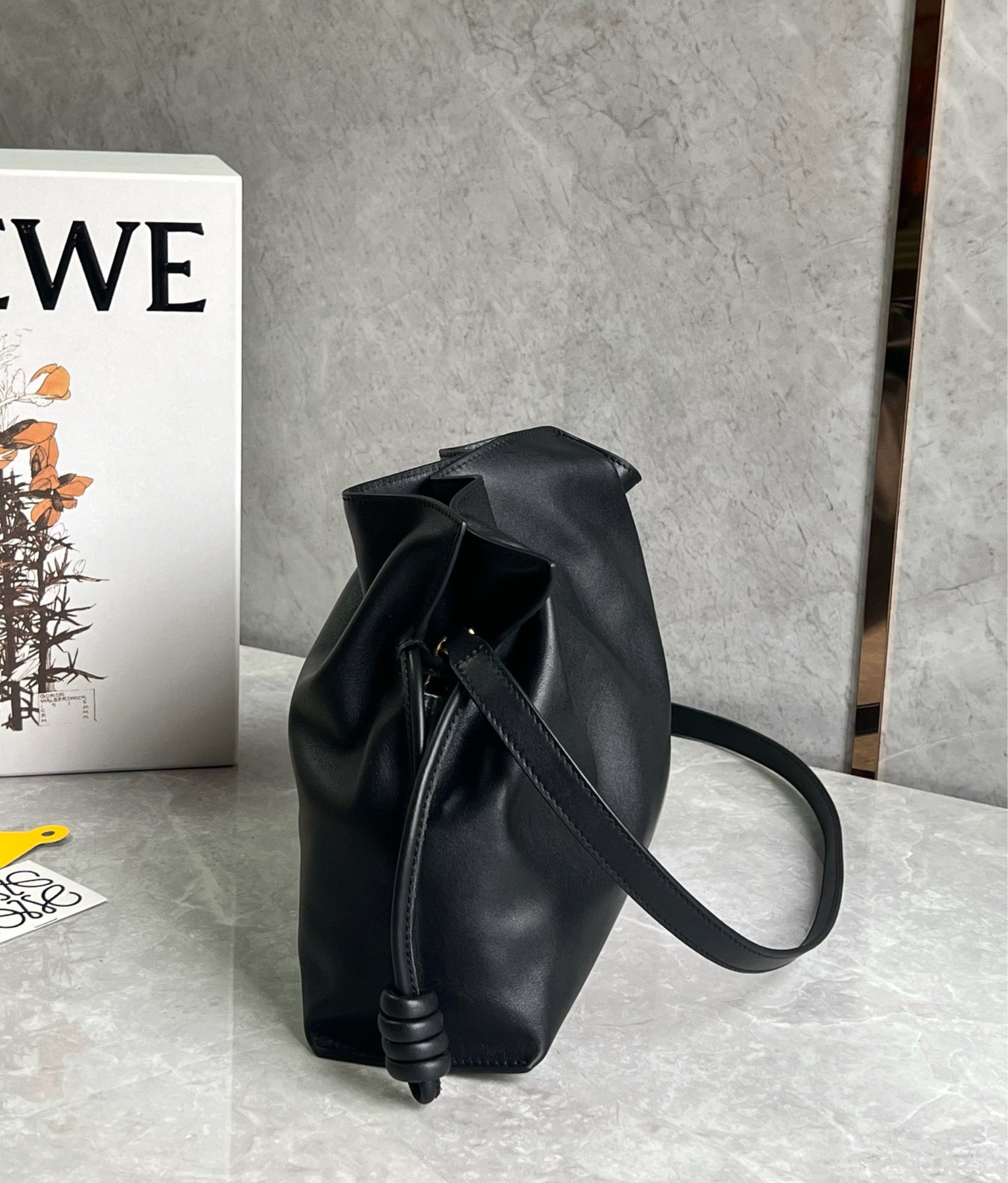 Loewe Black Leather flamenco Bag (Category: Luxury Bags & Wallets) located in Quezon City. Submitted by herluxe_official (Listing ID 1421067445, Image 3). Description: Loewe flamenco - Crafted from black leather - Stylish shoulder strap with knot details - Spacious interior with soft suede lining - Includes a small leather tag with the Loewe brand name - Comes with original Loewe box - Includes yellow tag Doesn’t have the loewe logo in the front 