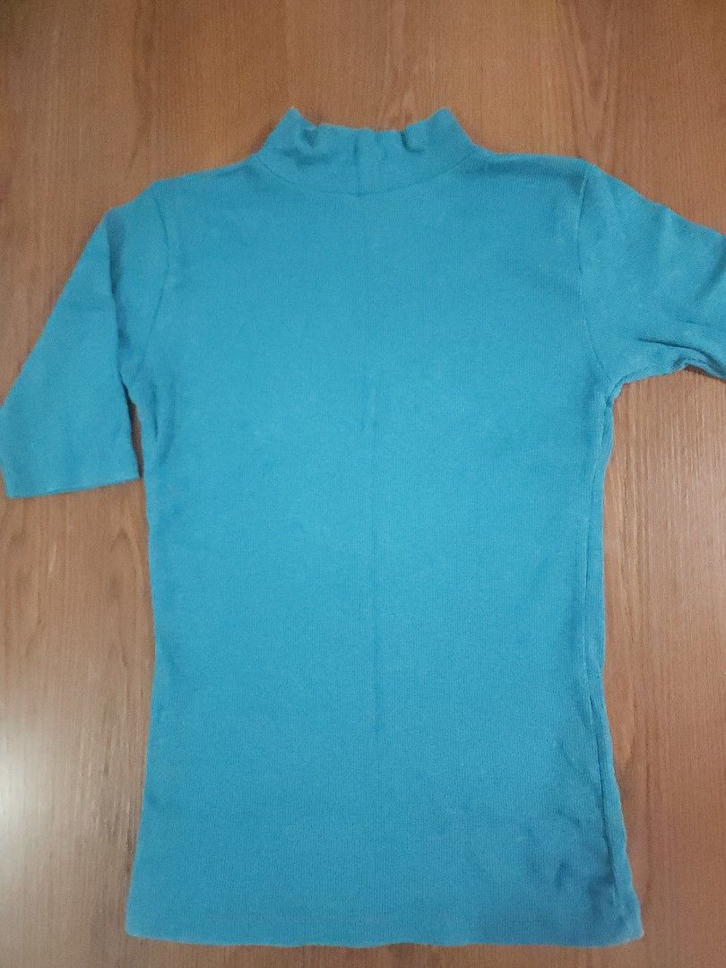 Lzda Teal Turtleneck Top - Size M (new) (Category: Sleeveless) located in Taguig. Submitted by cwonlinestore (Listing ID 1420986097, Image 3). Description: - Lzda teal turtleneck top - Size: M - Features: Short sleeves, ribbed knit texture, mock neck - Style: Fitted silhouette - Color: Vibrant teal - Material: Knit fabric - Versatile: Can be dressed up or down.