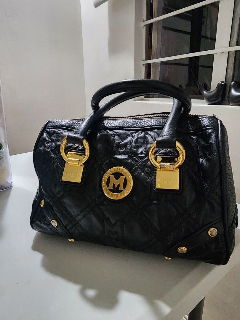 Metrocity Black Handbag (Category: Luxury Bags & Wallets) located in Manila. Submitted by babygirl.luxxe (Listing ID 1421112966, Image 1). Description: Black Metrocity handbag with gold-tone hardware. Features a quilted design, top handles, and a zip closure. Includes gold-tone accents and a Metrocity logo on the front. Structure is very good faded lang sa mga hardware.