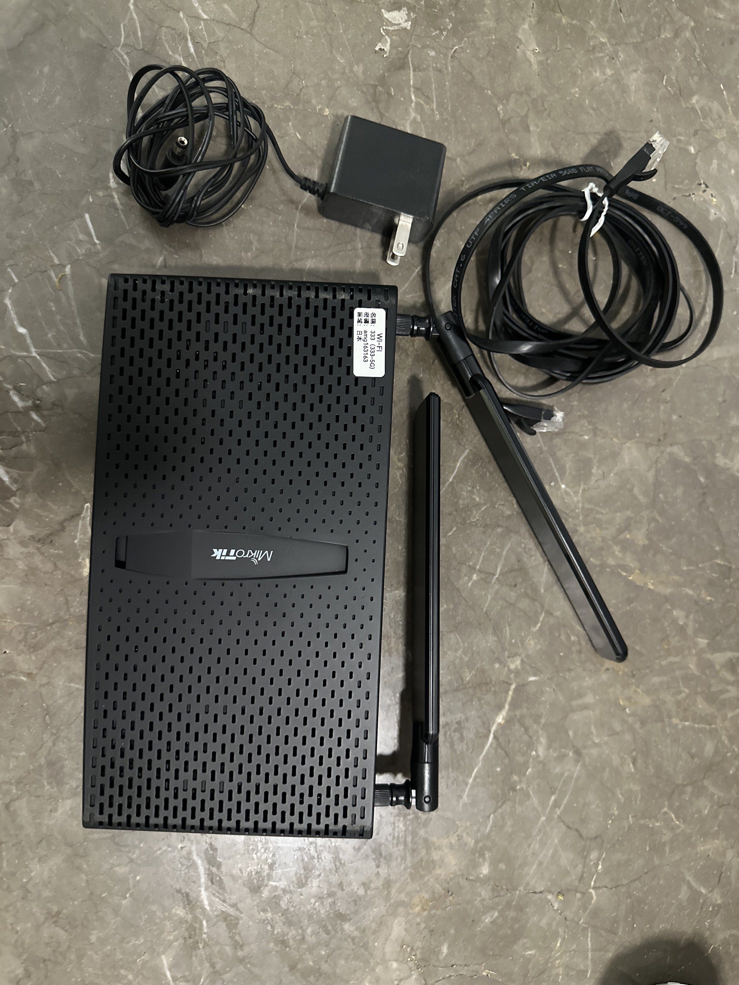 MikroTik Wireless Router (Category: Networking) located in Makati City. Submitted by rosessakura80 (Listing ID 1421088913, Image 1). Description: - MikroTik wireless router - Includes power adapter and Ethernet cable - Features two antennas - Black color - Ideal for home or small office - Ready to use.