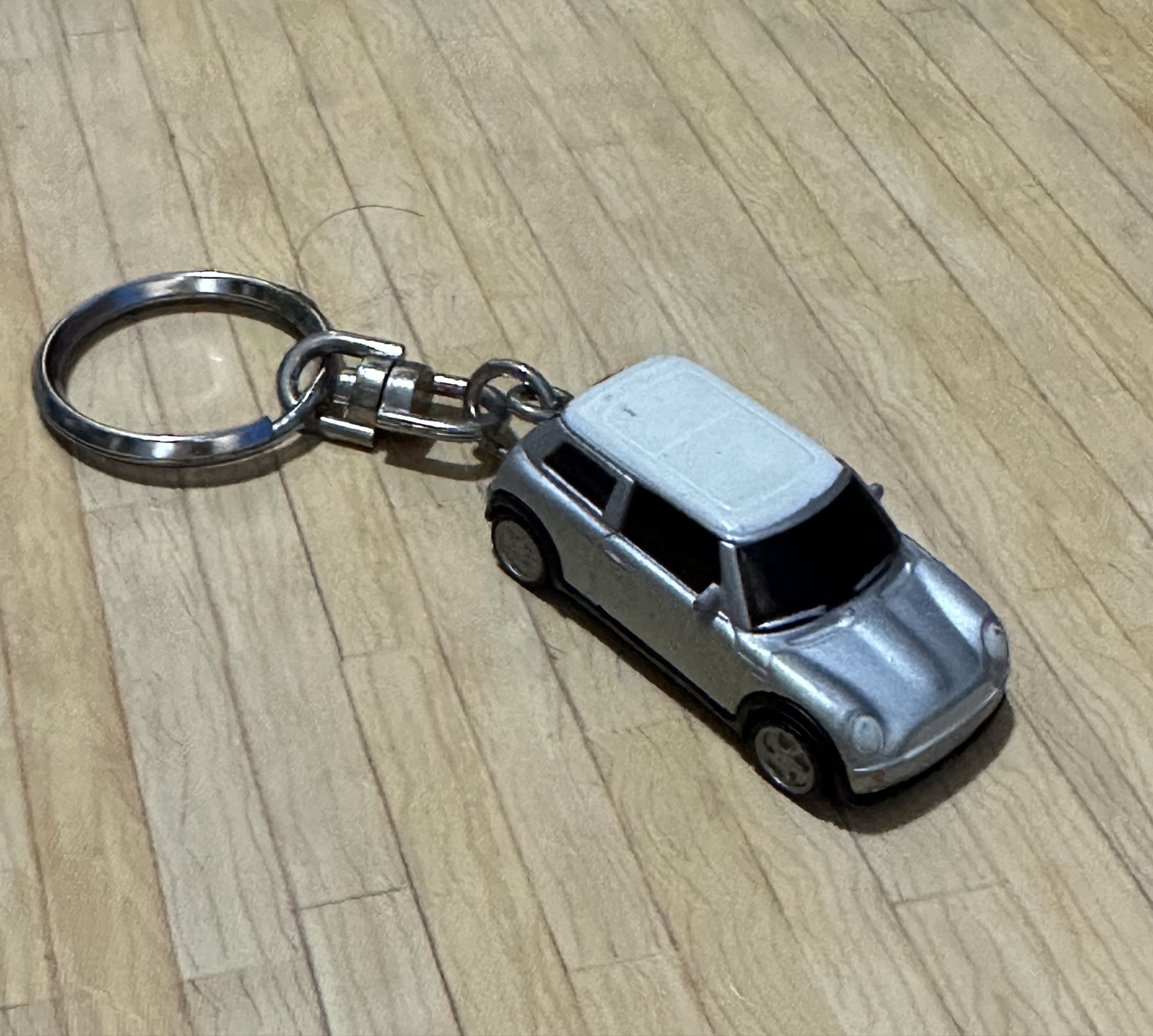 Mini Cooper Diecast Keychain White and Silver Metallic (Category: Vehicle & Diecast Models) located in General Santos City (Dadiangas). Submitted by toysville888 (Listing ID 1421034882, Image 3). Description: - Mini Cooper keychain - Miniature silver car model with a white roof - Made of metal - Underside marked "NO. 98839" and "MADE IN CHINA" - Attached to a keyring.