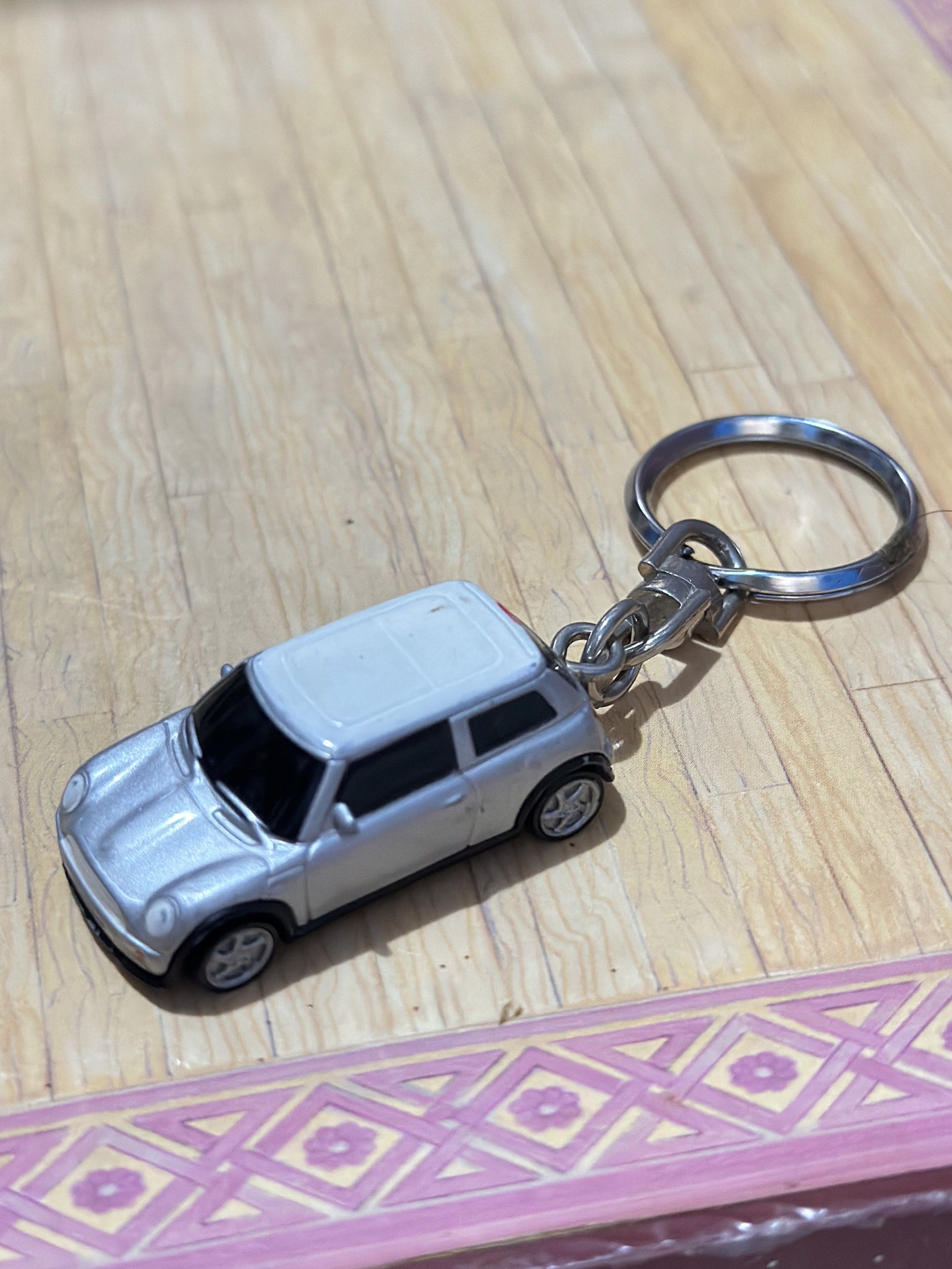 Mini Cooper Diecast Keychain White and Silver Metallic (Category: Vehicle & Diecast Models) located in General Santos City (Dadiangas). Submitted by toysville888 (Listing ID 1421034882, Image 2). Description: - Mini Cooper keychain - Miniature silver car model with a white roof - Made of metal - Underside marked "NO. 98839" and "MADE IN CHINA" - Attached to a keyring.