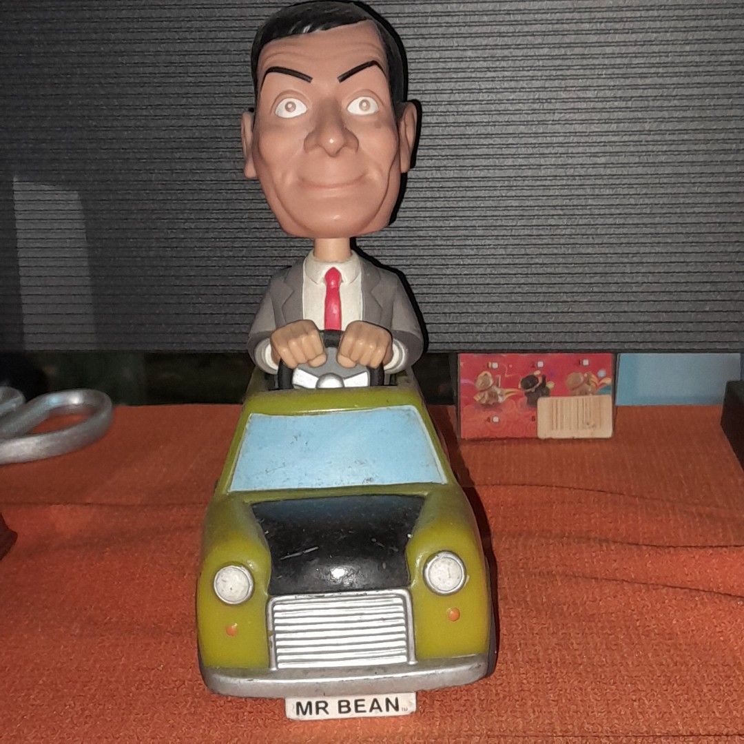Mr. Bean Car Figurine (Category: Vehicle & Diecast Models) located in Baguio. Submitted by shellcollector (Listing ID 1420969220, Image 3). Description: - Mr. Bean figurine. - Features Mr. Bean in his iconic car. - Color: Yellow and Blue. - Car license plate reads "MR BEAN". - Base markings: "Aspect Productions Ltd 2007" and "Funko LLC 2007 2500 Pesos Baguio shipping.