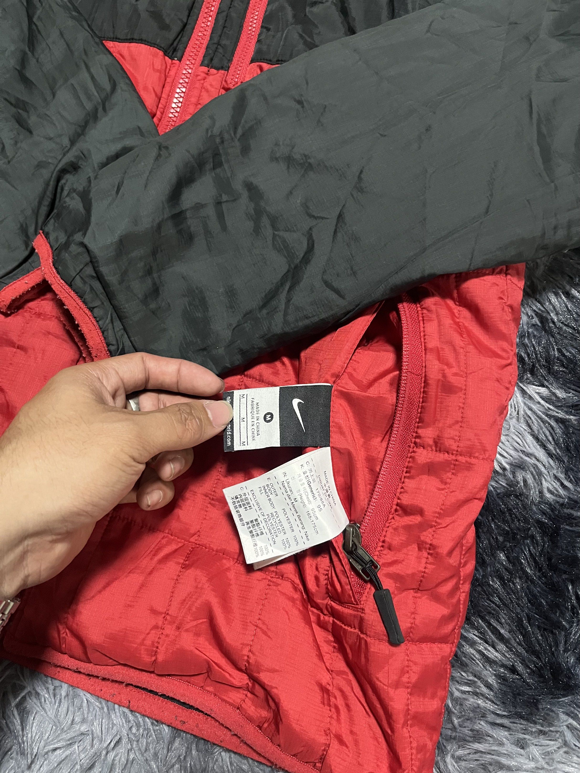 Nike Manchester United Reversible Jacket (Category: Coats, Jackets and Outerwear) located in Santa Rosa. Submitted by _unclethrifts (Listing ID 1421096235, Image 3). Description: - Reversible Manchester United jacket. - One side: Black with red accents. - Other side: Red with black accents. - Includes a hood. - Full-length zipper. - Nike logo on the chest. - Size tag present..