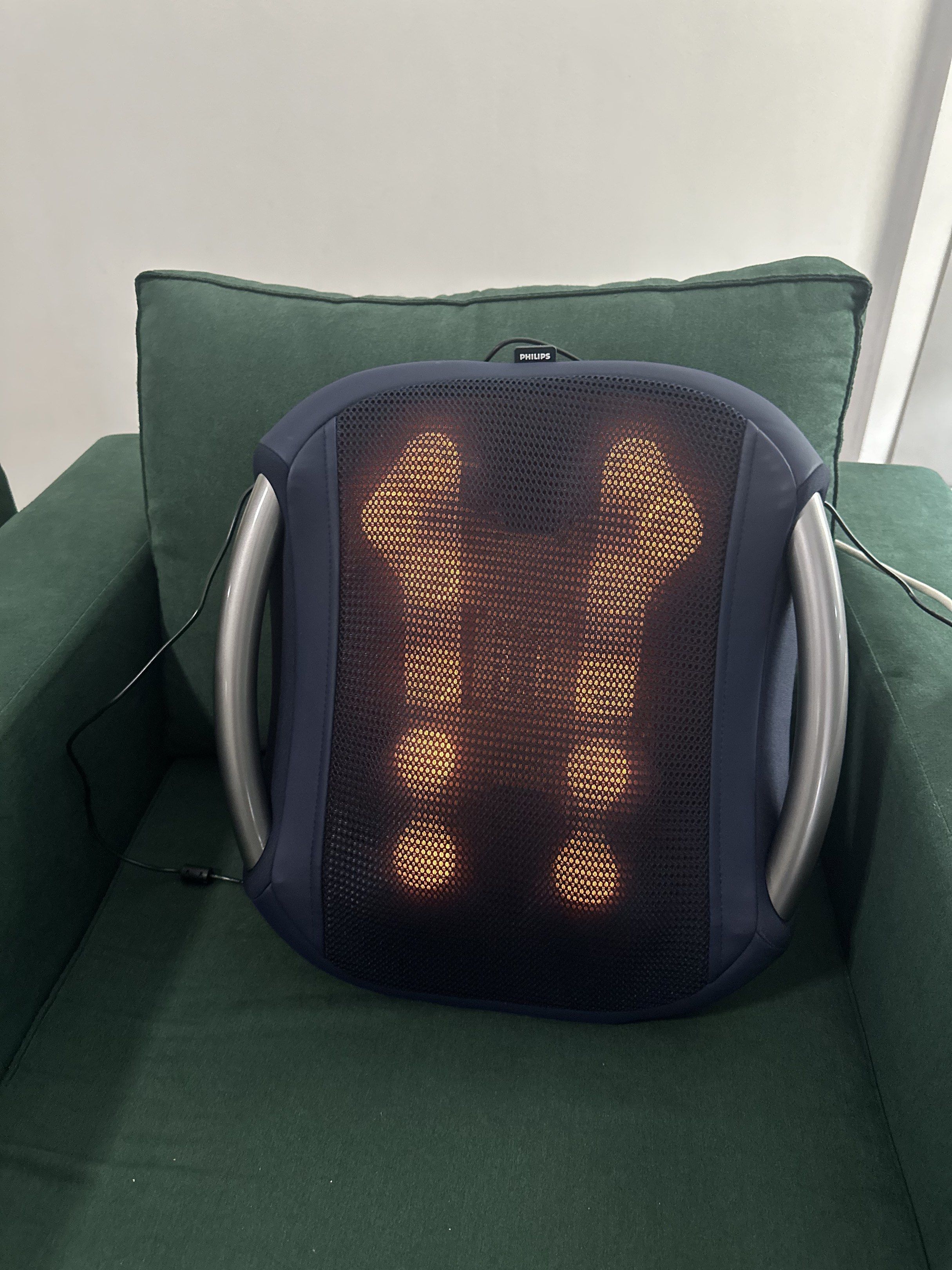 Philips Shiatsu Massage Cushion (Category: Massage Devices) located in Makati City. Submitted by rosessakura80 (Listing ID 1421086109, Image 1). Description: - Philips Shiatsu massage cushion - Dark blue mesh front - Illuminated massage nodes - Silver handles - Designed for chair use - Includes power cord - Provides a relaxing massage experience.