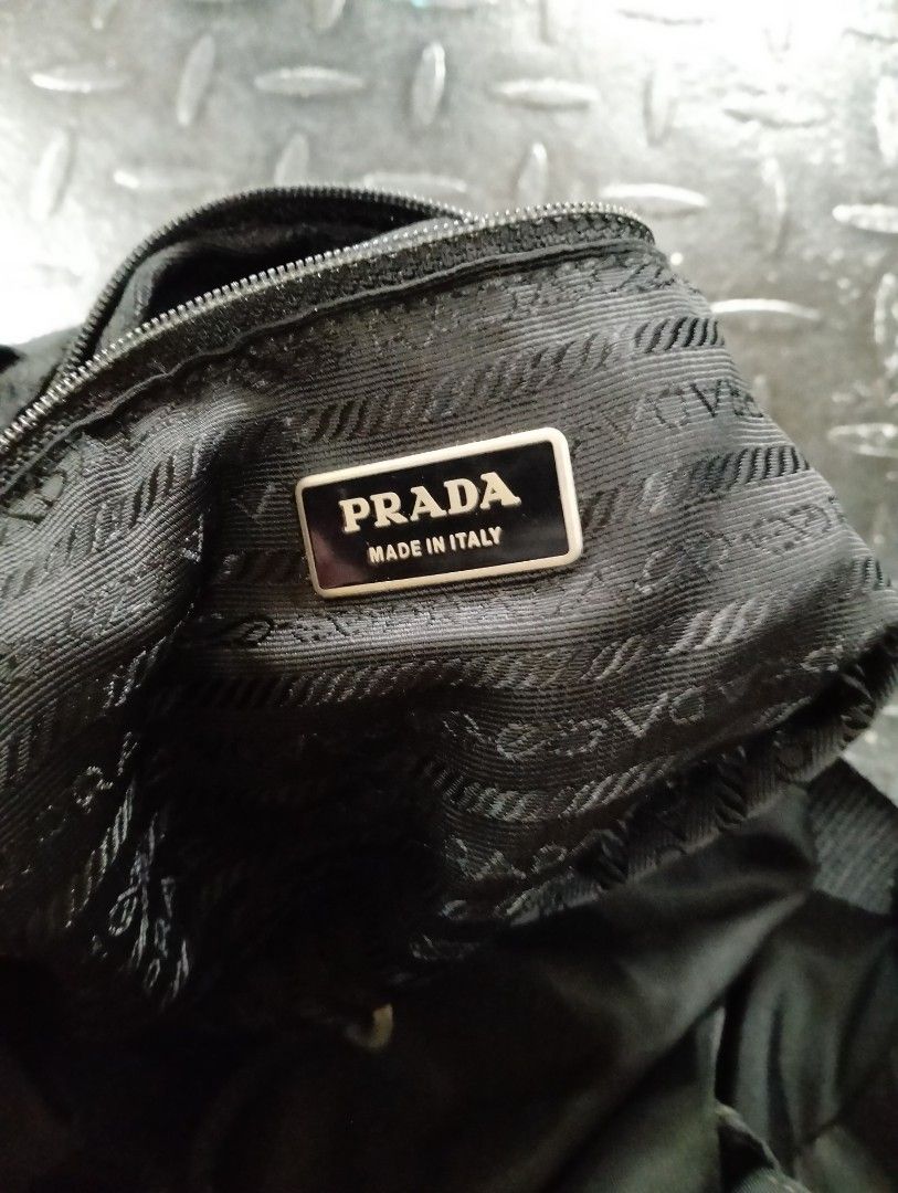 Prada Nylon Backpack (Category: Luxury Bags & Wallets) located in Manila. Submitted by style.culture (Listing ID 1420998695, Image 3). Description: - Authentic Prada backpack - Black nylon material - Prada logo on front and interior - Adjustable shoulder straps - Multiple compartments - Interior lining with Prada logo pattern - Made in Italy - Zipper closure.