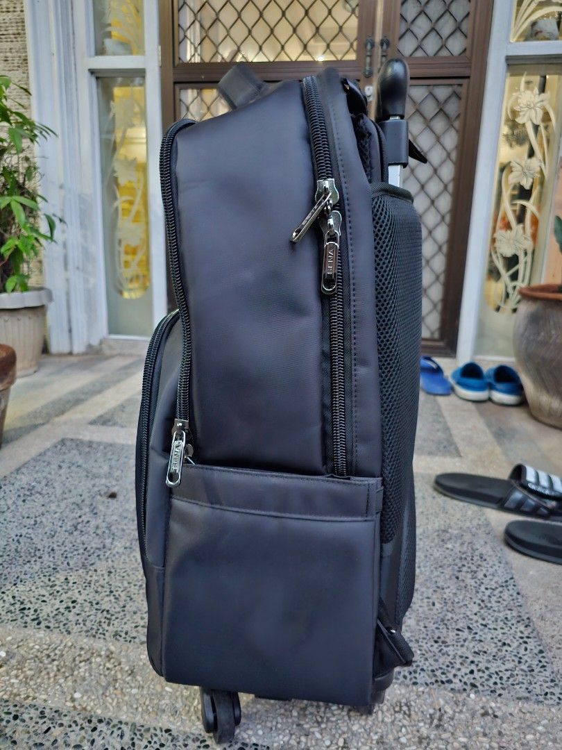 SENA Rolling Backpack (Category: Backpacks) located in Manila. Submitted by anjelincloset (Listing ID 1420975373, Image 3). Description: Durable SENA rolling backpack - Black exterior - Multiple compartments with zippered closures - Top handle for carrying - Retractable handle for rolling - Padded mesh back for comfort - 4 rolling wheels - Ideal for travel or work essentials Bought for 3k+ Used for 2x only Like new.