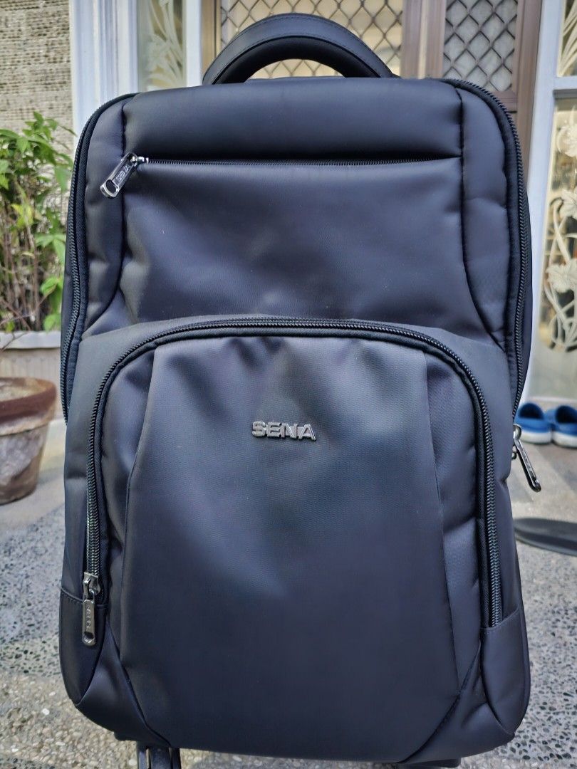 SENA Rolling Backpack (Category: Backpacks) located in Manila. Submitted by anjelincloset (Listing ID 1420975373, Image 1). Description: Durable SENA rolling backpack - Black exterior - Multiple compartments with zippered closures - Top handle for carrying - Retractable handle for rolling - Padded mesh back for comfort - 4 rolling wheels - Ideal for travel or work essentials Bought for 3k+ Used for 2x only Like new.