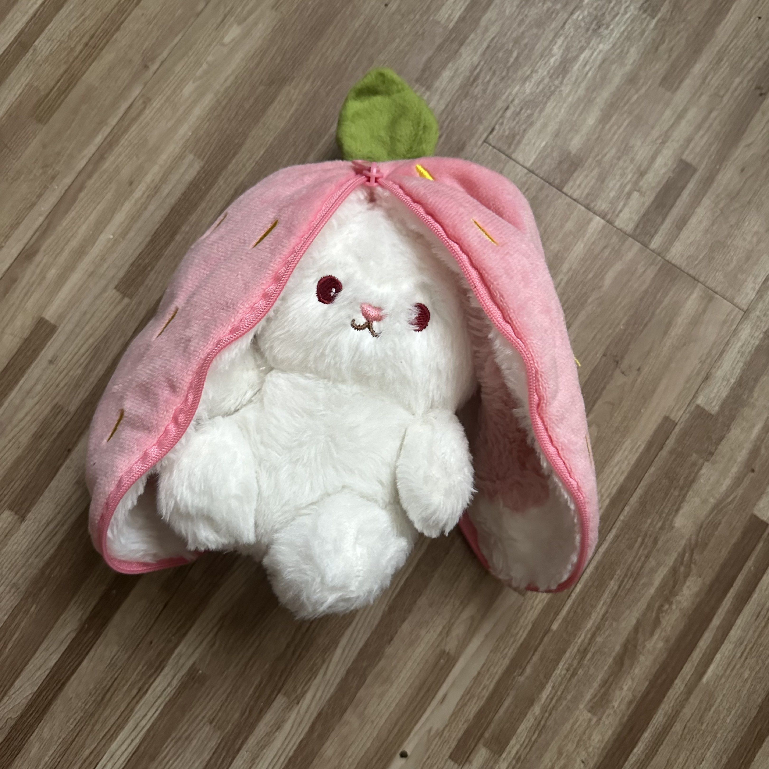 Strawberry Bunny Plush Toy (Category: Plushies & Soft Toys) located in Marilao. Submitted by extra_stuff (Listing ID 1420993248, Image 1). Description: - Adorable white bunny plush toy. - Features red eyes and a small embroidered face. - Includes a pink, strawberry-shaped cover. - Strawberry cover has green leaves and yellow embroidered seeds. - Bunny's ears are extendable..
