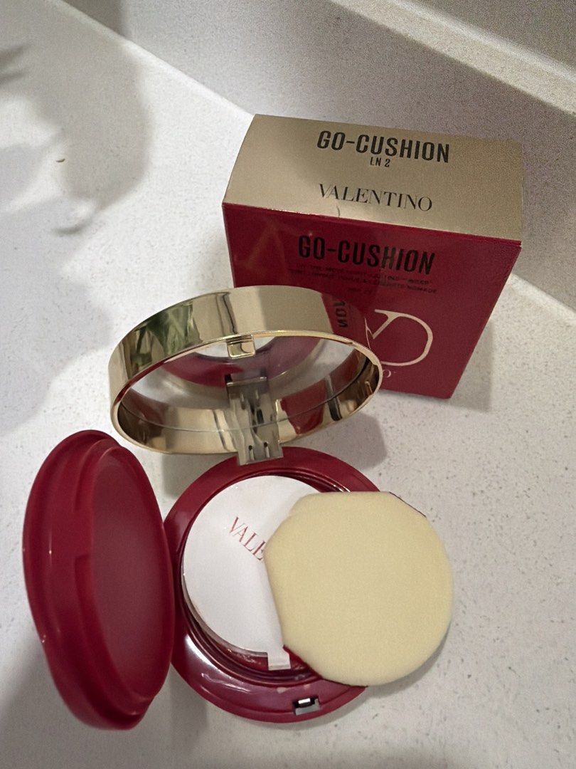 Valentino Go-Cushion (Category: Makeup) located in Cainta. Submitted by mycosy.life (Listing ID 1421062130, Image 3). Description: - Valentino Go-Cushion Foundation in shade LN2 - Very high end makeup - Provides light, long-lasting wear - Offers SPF 23 protection - Comes with original packaging - Features a red and gold Valentino compact design - Includes a sponge applicator.