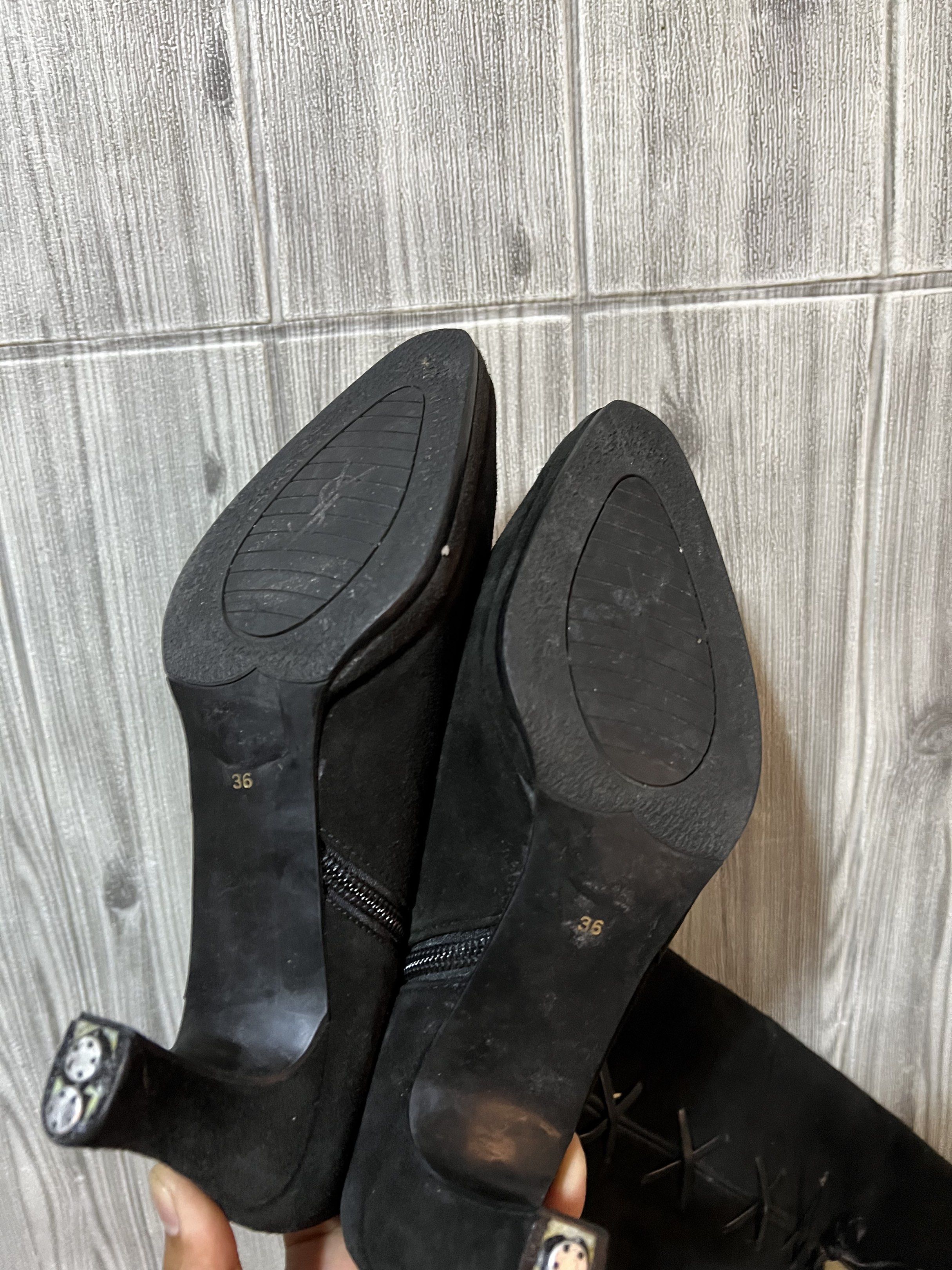 Yves Saint Laurent Black Suede Boots (Category: Boots) located in Binmaley. Submitted by jayvecatalan21 (Listing ID 1420991650, Image 3). Description: Elegant black suede boots from Yves Saint Laurent. Features a pointed toe and a small heel. The boots have a side zipper and lace-up detailing. The size is 36. The interior is a gold color. The soles show some wear..