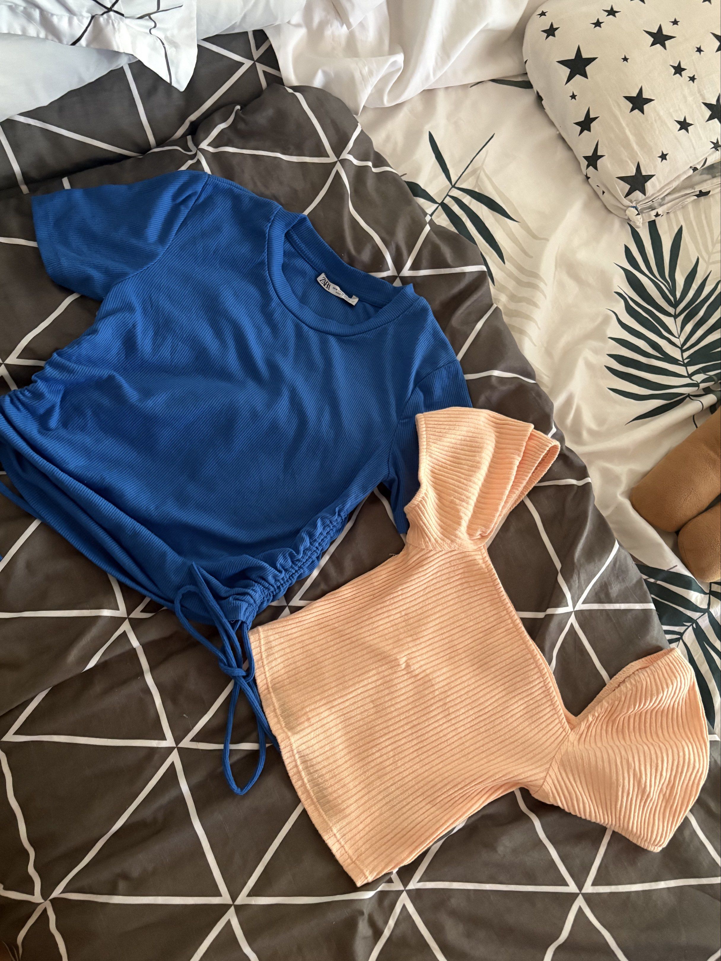 Zara Blue Top & H&M Peach Top Set (Category: Blouses) located in Dagupan City. Submitted by againandadorned (Listing ID 1421000935, Image 1). Description: - Zara Blue Top (Size M) - H&M Peach Top (Size XS) - Both made of ribbed fabric - Blue top features a drawstring - Peach top has a unique design.