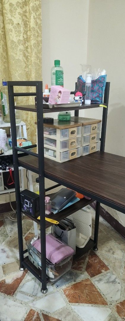 4 tier mahoganny study table (Category: Tables & Sets) located in Manila. Submitted by summerstyled (Listing ID 1421249442, Image 1). Description: - Industrial style desk - Dark wood-grain tabletop - Black metal frame - Multiple shelves for storage - Spacious work surface - Ideal for study or work - Stylish and functional design.