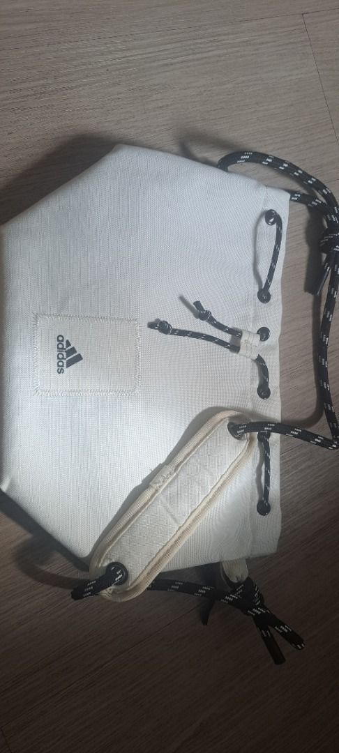 Adidas Drawstring Bag (Category: Backpacks) located in Manila. Submitted by rsamselleracc_fire (Listing ID 1421130267, Image 3). Description: - Adidas drawstring bag - White color - Black drawstring closure - Shoulder strap - Light pink interior - Adidas logo on front - Perfect for essentials.