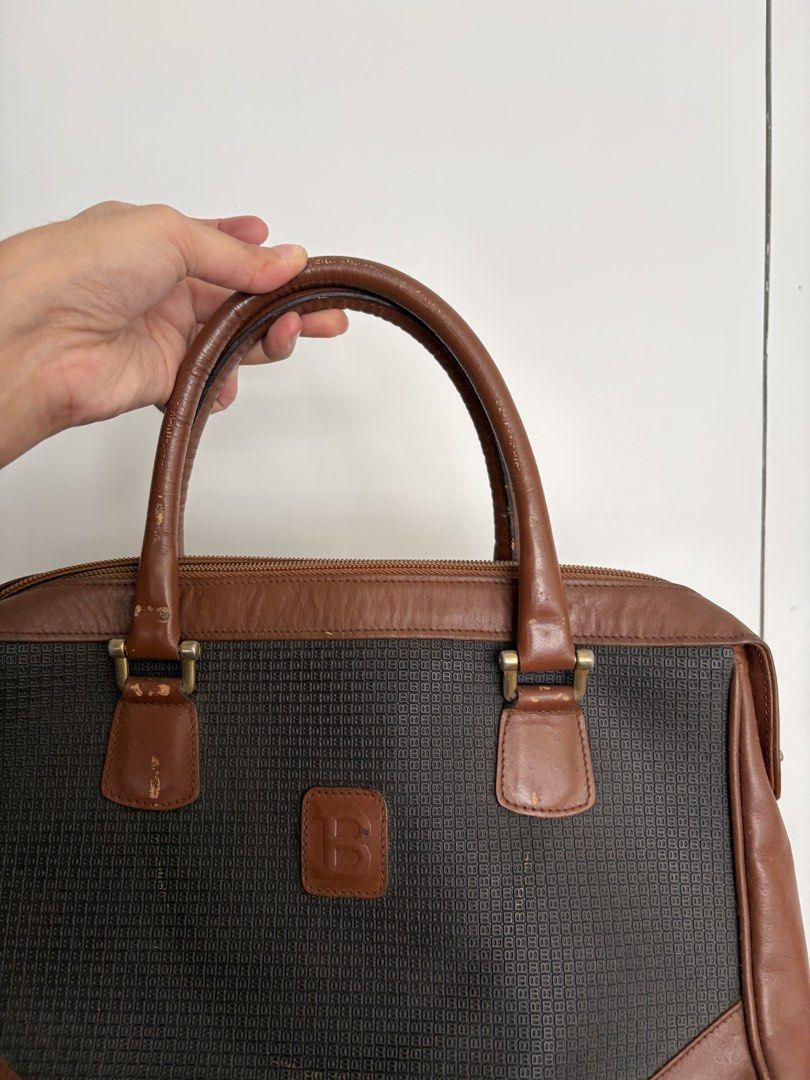 Bally Vintage Handbag with Brown Leather (Category: Luxury Bags & Wallets) located in Makati City. Submitted by lenyfelix (Listing ID 1421198680, Image 2). Description: - Vintage handbag - Black woven fabric center - Brown leather accents - Two handles - Top zipper closure - Interior pocket - Rectangular shape - Logo on front - Signs of wear on corners and handles.