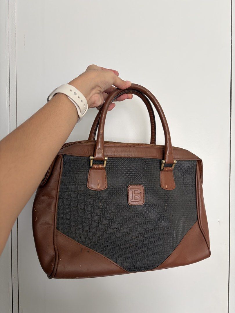 Bally Vintage Handbag with Brown Leather (Category: Luxury Bags & Wallets) located in Makati City. Submitted by lenyfelix (Listing ID 1421198680, Image 1). Description: - Vintage handbag - Black woven fabric center - Brown leather accents - Two handles - Top zipper closure - Interior pocket - Rectangular shape - Logo on front - Signs of wear on corners and handles.
