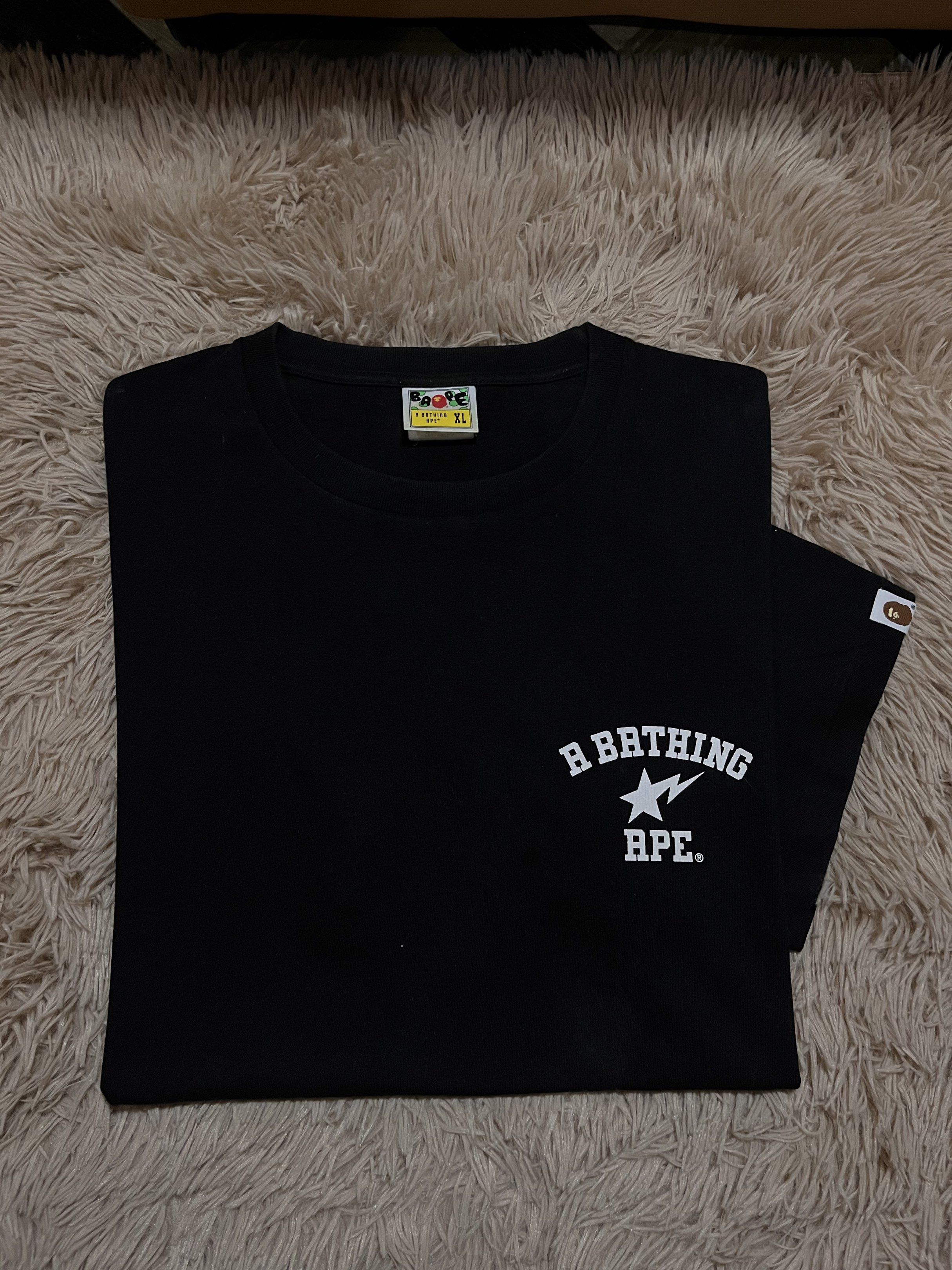 BAPE Black T-shirt XL (Category: Tshirts & Polo Shirts ) located in Manila. Submitted by siocojay04 (Listing ID 1421224734, Image 1). Description: - Black BAPE T-shirt - Size: XL - Features the iconic A Bathing Ape logo on the front - Bold BAPE graphic on the back - Includes authentic BAPE sleeve tag - Classic crew neck design.