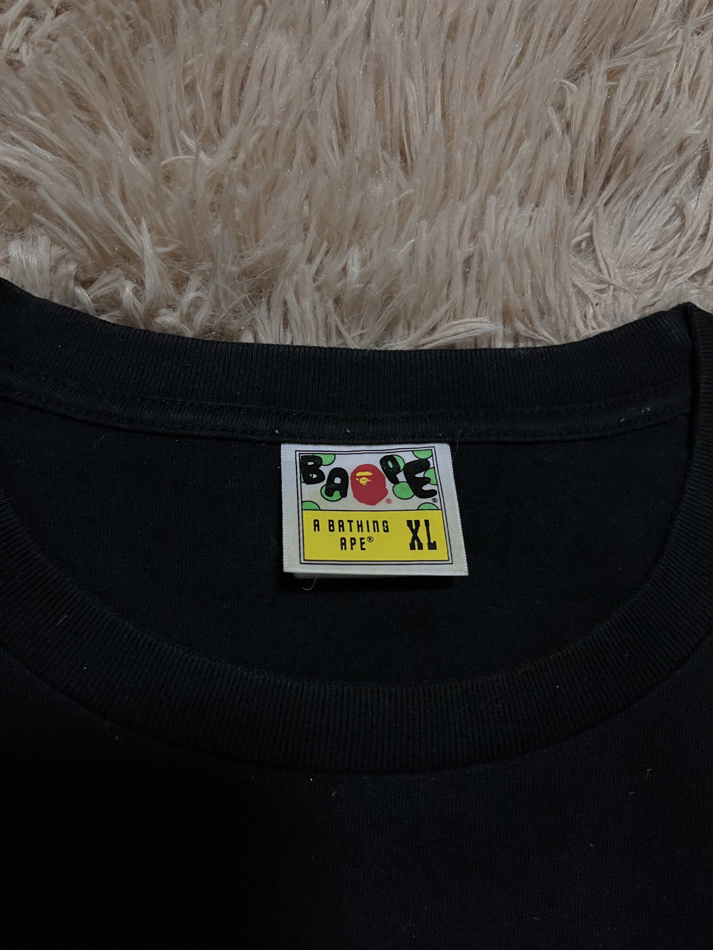 BAPE Black T-shirt XL (Category: Tshirts & Polo Shirts ) located in Manila. Submitted by siocojay04 (Listing ID 1421224734, Image 3). Description: - Black BAPE T-shirt - Size: XL - Features the iconic A Bathing Ape logo on the front - Bold BAPE graphic on the back - Includes authentic BAPE sleeve tag - Classic crew neck design.