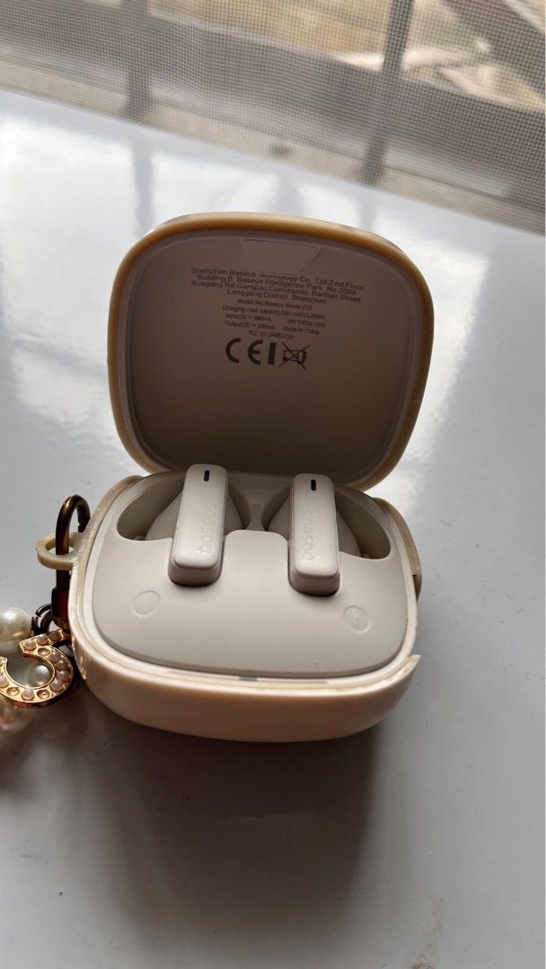 BASEUS TWS Earphones with Charging Case (Category: Earphones) located in Quezon City. Submitted by charlottes_boutique (Listing ID 1410404077, Image 1). Description: White TWS earphones with a charging case and USB-C charging cable. Includes extra ear tips for a customized fit. The earphones have a sleek, modern design. The charging case is compact and easy to carry. Perfect for listening to music or taking calls on the go..