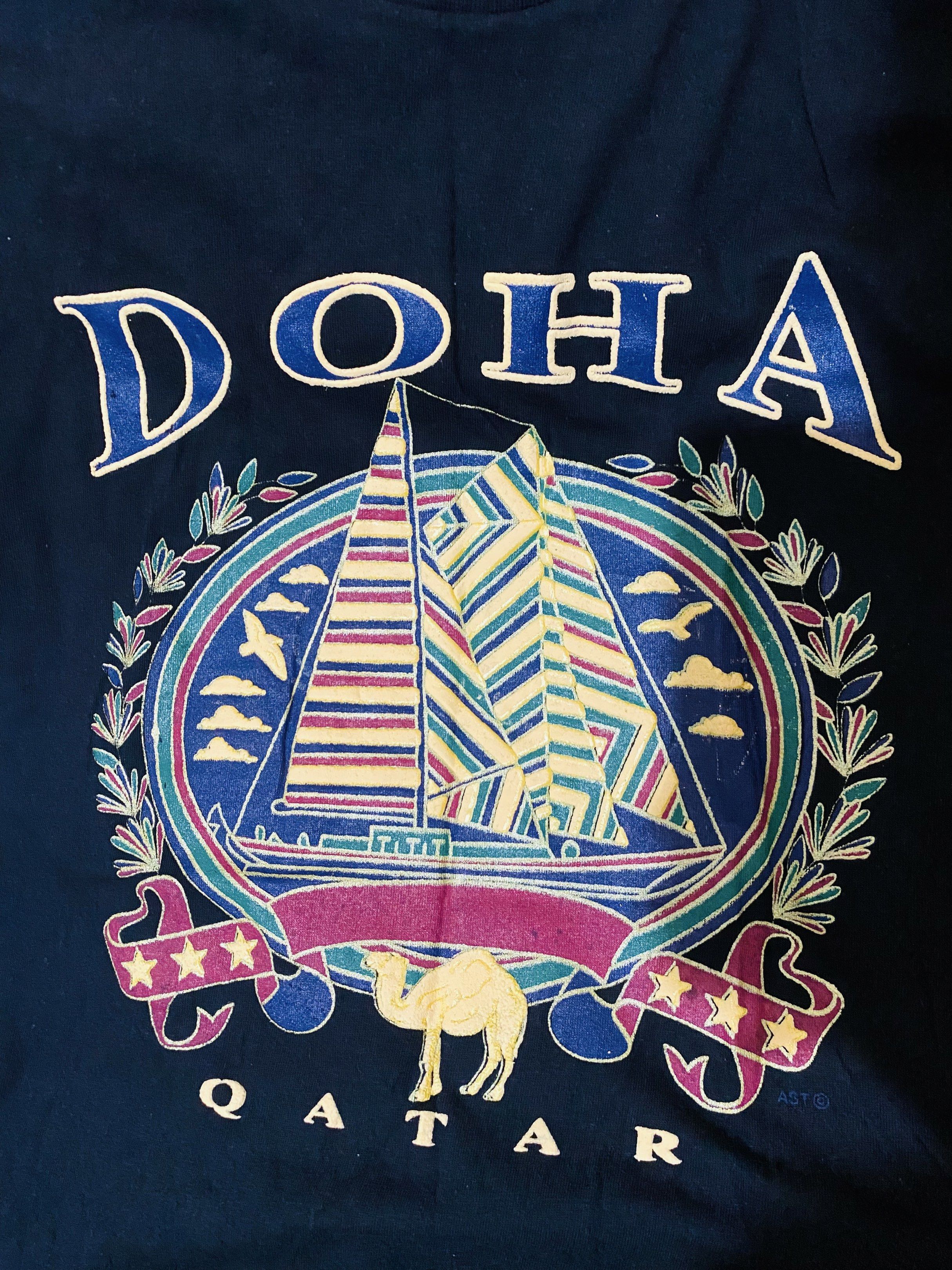 Black Doha Qatar Graphic T-shirt (Category: Tshirts & Polo Shirts ) located in Quezon City. Submitted by hirono18 (Listing ID 1421214006, Image 2). Description: - BLACK graphic t-shirt - Design includes a sailboat, camel, and stars - Crew neck style - Plain black back - Cotton soft.