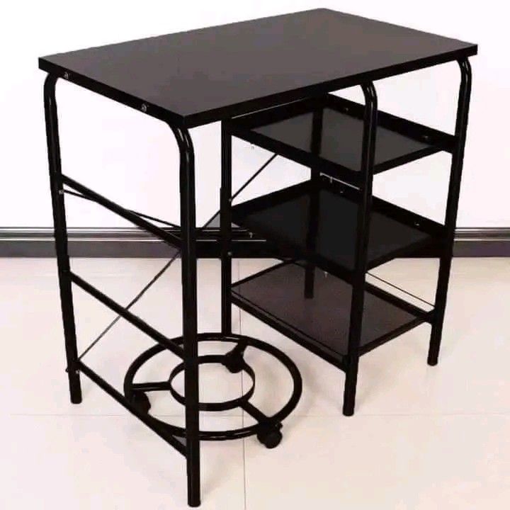 Black Kitchen Cart with Shelves (Category: Shelves, Cabinets & Racks) located in Quezon City. Submitted by anghies_shop (Listing ID 1421254602, Image 1). Description: Black kitchen cart features a tabletop and three shelves for storage. It has a sturdy metal frame and a circular base with wheels for easy mobility. The cart is ideal for organizing kitchen essentials or serving as a compact workstation. Its design is simple and functional, suitable