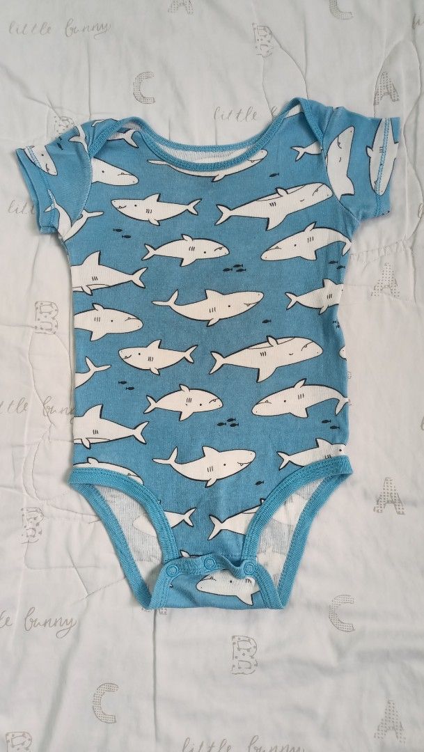 Carter's Shark Print Onesie 9M (Category: Babies & Kids Fashion) located in Quezon City. Submitted by _itsmemarie_ (Listing ID 1421190512, Image 1). Description: - Carter's onesie - Fun shark print - For babies aged 9 months - 100% cotton - Blue base color - White shark illustrations - Made in China.