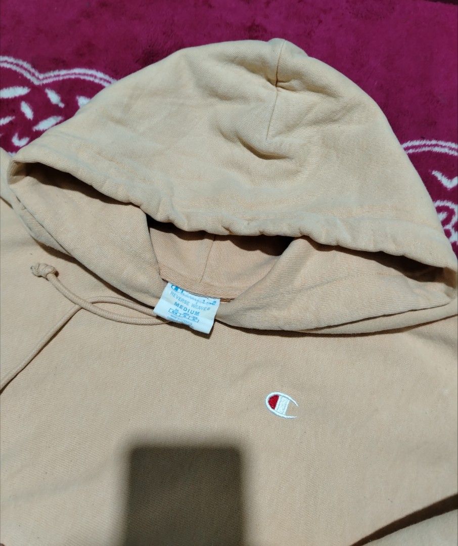 Champion Hoodie (Category: Coats, Jackets and Outerwear) located in Lucena. Submitted by thrifteditem (Listing ID 1421291968, Image 2). Description: - Champion hoodie - Reverswave - Light brown color - Hood with drawstrings - Kangaroo pocket - Champion logo on chest and sleeve - Made of thick, comfortable material - Tag visible in photos.