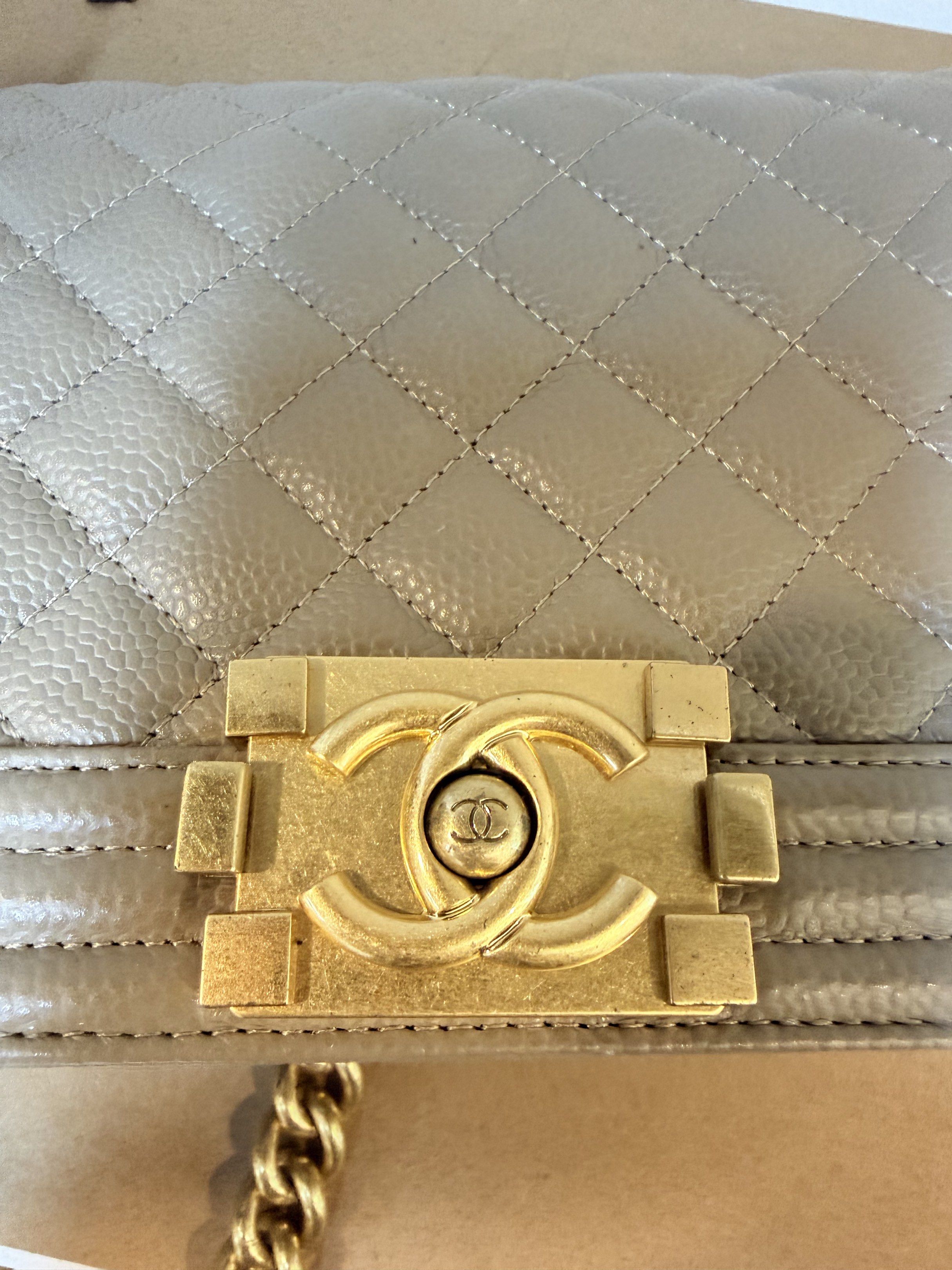 Chanel Boy Bag from Thrift shop (Category: Luxury Bags & Wallets) located in Manila. Submitted by denkim (Listing ID 1421162423, Image 2). Description: - Chanel Boy Bag - Quilted design - Gold-tone chain strap - Signature CC clasp - Rectangular shape - Neutral exterior color NGA - Fabric lining - Interior pocket - Minor wear on hardware.
