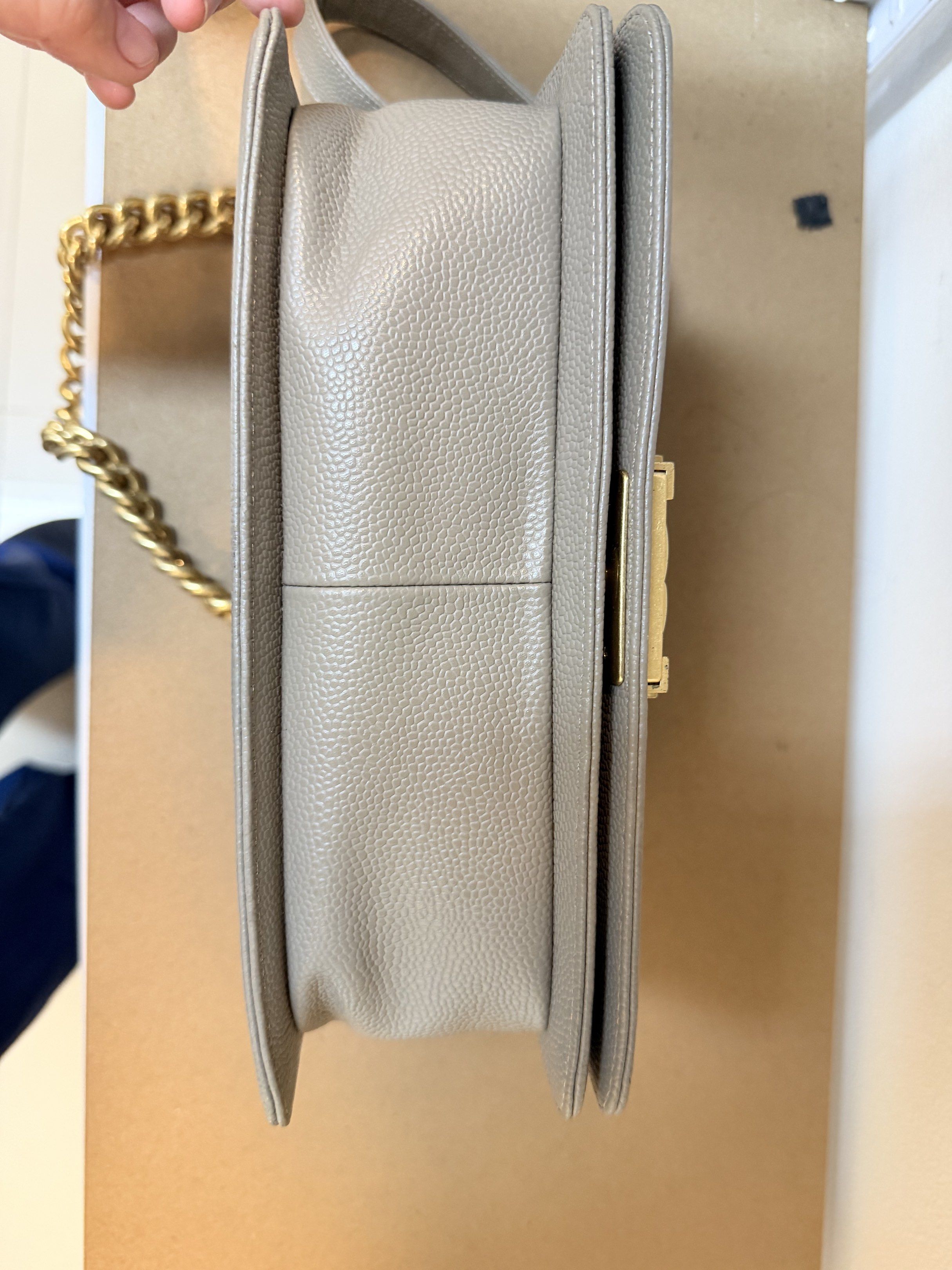 Chanel Boy Bag from Thrift shop (Category: Luxury Bags & Wallets) located in Manila. Submitted by denkim (Listing ID 1421162423, Image 3). Description: - Chanel Boy Bag - Quilted design - Gold-tone chain strap - Signature CC clasp - Rectangular shape - Neutral exterior color NGA - Fabric lining - Interior pocket - Minor wear on hardware.