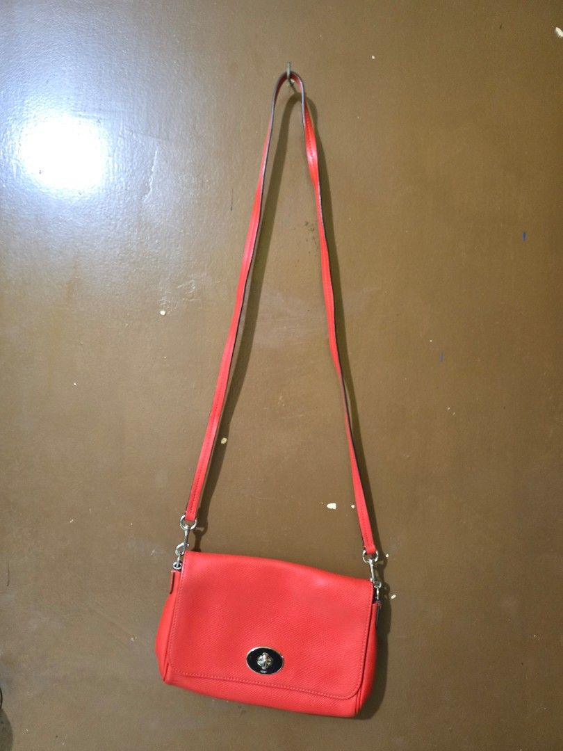 Coach Mini Ruby Crossbody Bag (Category: Luxury Bags & Wallets) located in Las Pinas. Submitted by zeiralliv (Listing ID 1421192344, Image 2). Description: Coach Mini Ruby Sling Model: F1592-F34604 Color: Orange (leaning to red orange) Hardware: Silver tone Condition: Good used condition Issue: • Missing short chain strap • Missing hangtag • Scruff mark on one side near the strap ring (see photos) • May need cleaning on the inside cloth lining on