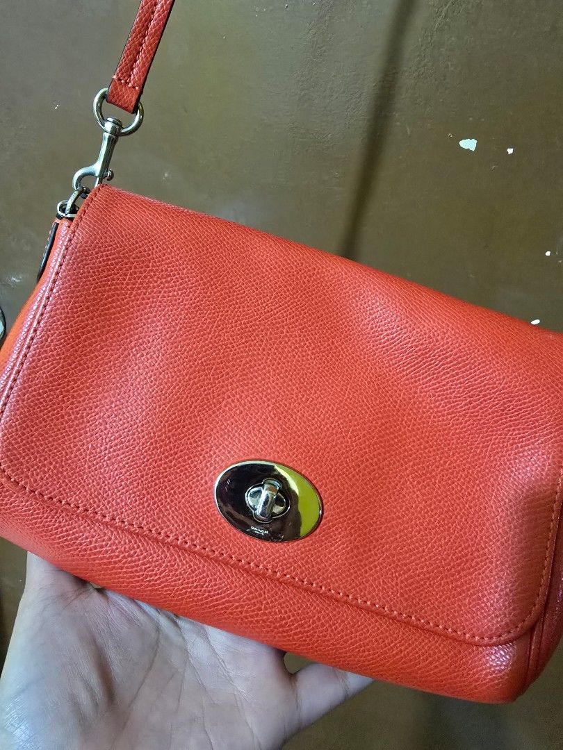 Coach Mini Ruby Crossbody Bag (Category: Luxury Bags & Wallets) located in Las Pinas. Submitted by zeiralliv (Listing ID 1421192344, Image 1). Description: Coach Mini Ruby Sling Model: F1592-F34604 Color: Orange (leaning to red orange) Hardware: Silver tone Condition: Good used condition Issue: • Missing short chain strap • Missing hangtag • Scruff mark on one side near the strap ring (see photos) • May need cleaning on the inside cloth lining on