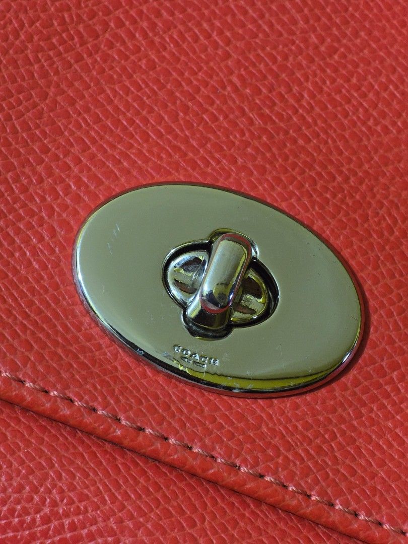 Coach Mini Ruby Crossbody Bag (Category: Luxury Bags & Wallets) located in Las Pinas. Submitted by zeiralliv (Listing ID 1421192344, Image 3). Description: Coach Mini Ruby Sling Model: F1592-F34604 Color: Orange (leaning to red orange) Hardware: Silver tone Condition: Good used condition Issue: • Missing short chain strap • Missing hangtag • Scruff mark on one side near the strap ring (see photos) • May need cleaning on the inside cloth lining on